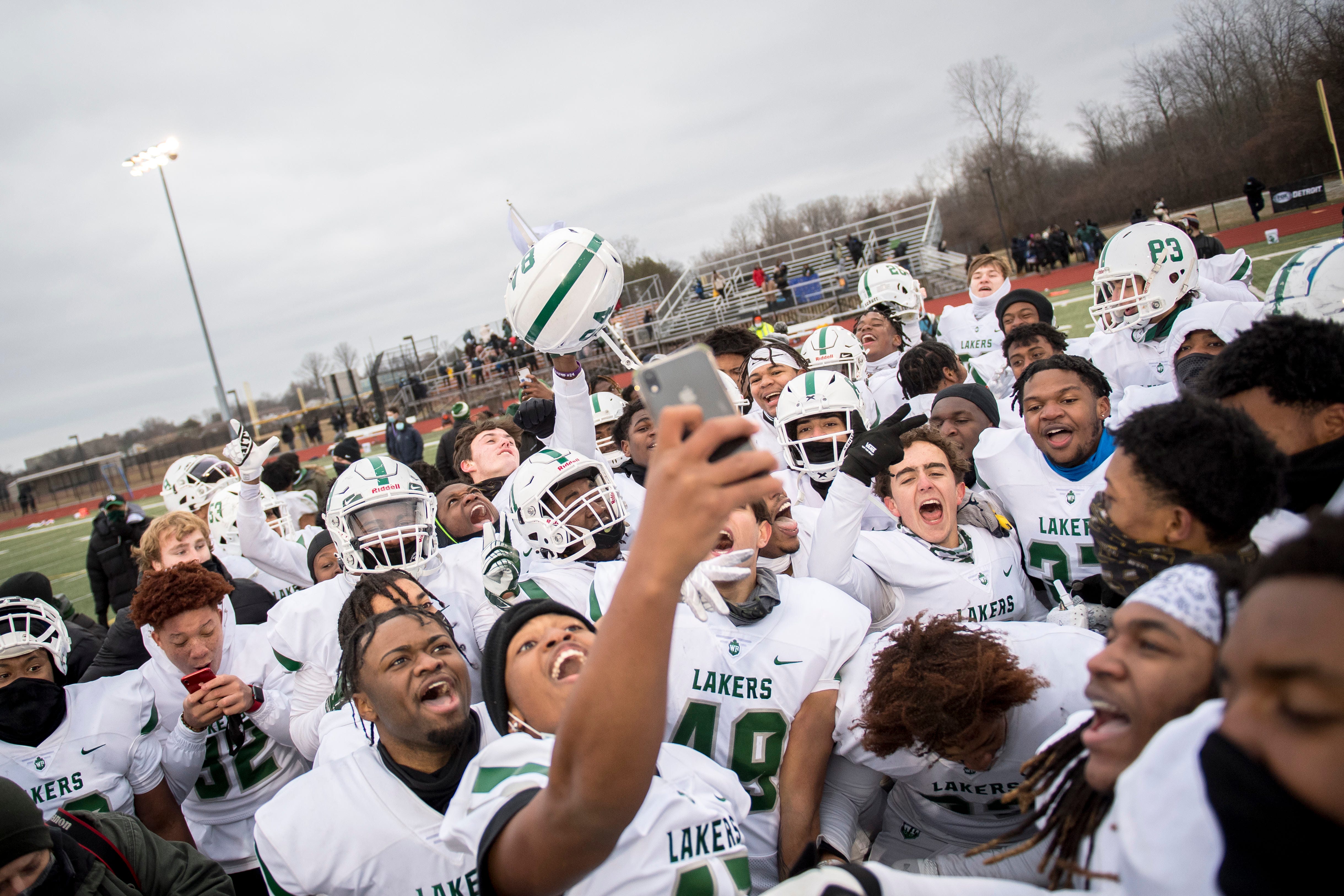 West Bloomfield celebrates their win against Belleville in double overtime, 35-34, at Belleville.