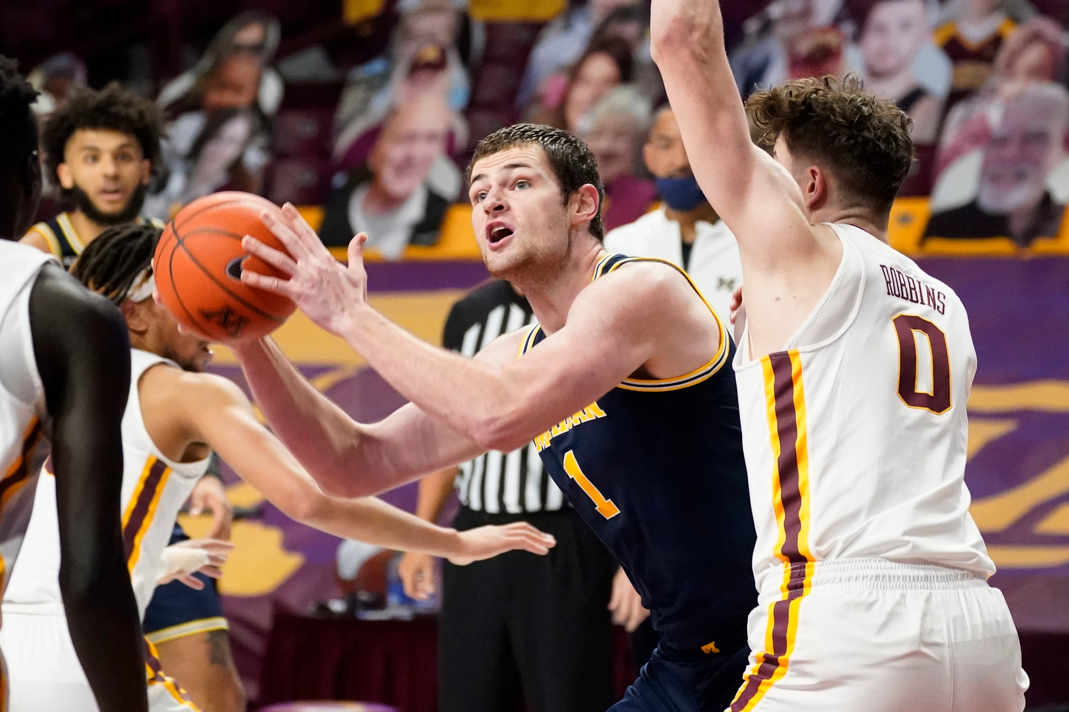 Michigan's Hunter Dickinson (1) drives as Minnesota's Liam Robbins (0) defends in the second half.