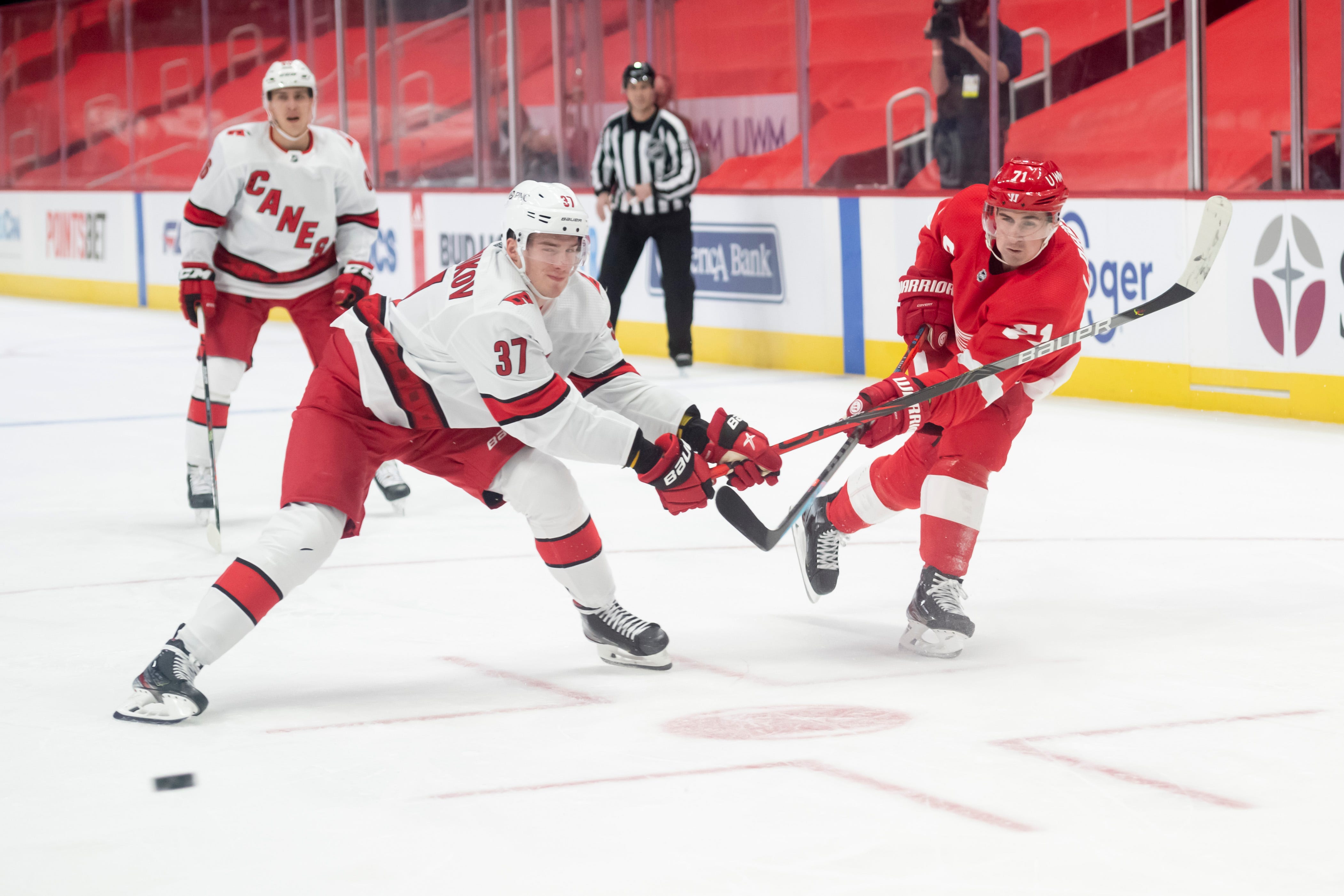 Detroit center Dylan Larkin shoots the puck while being defended by Carolina right wing Andrei Svechnikov in the first period.