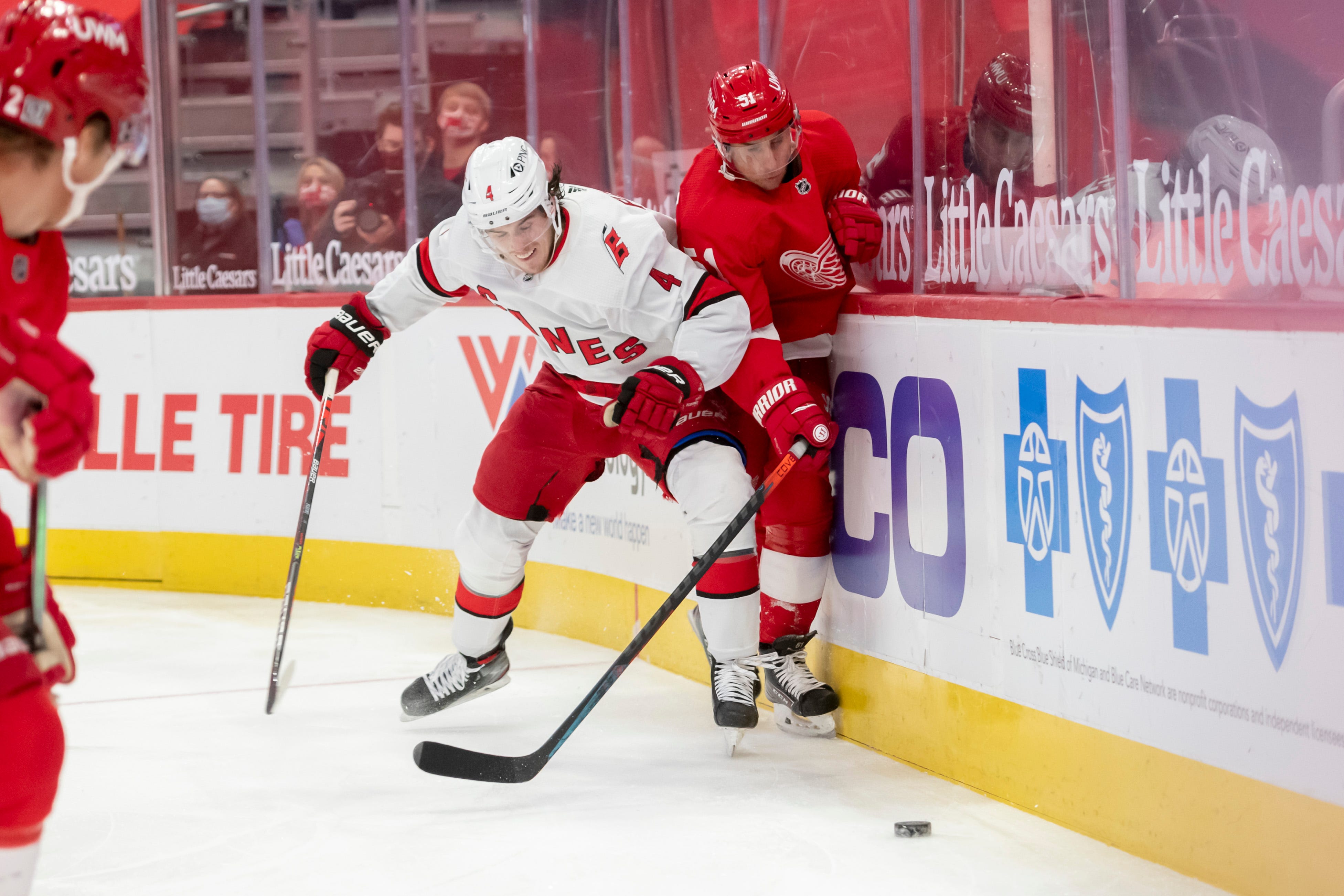 Carolina defenseman Haydn Fleury and Detroit center Valtteri Filppula battle for the puck along the boards in the third period.