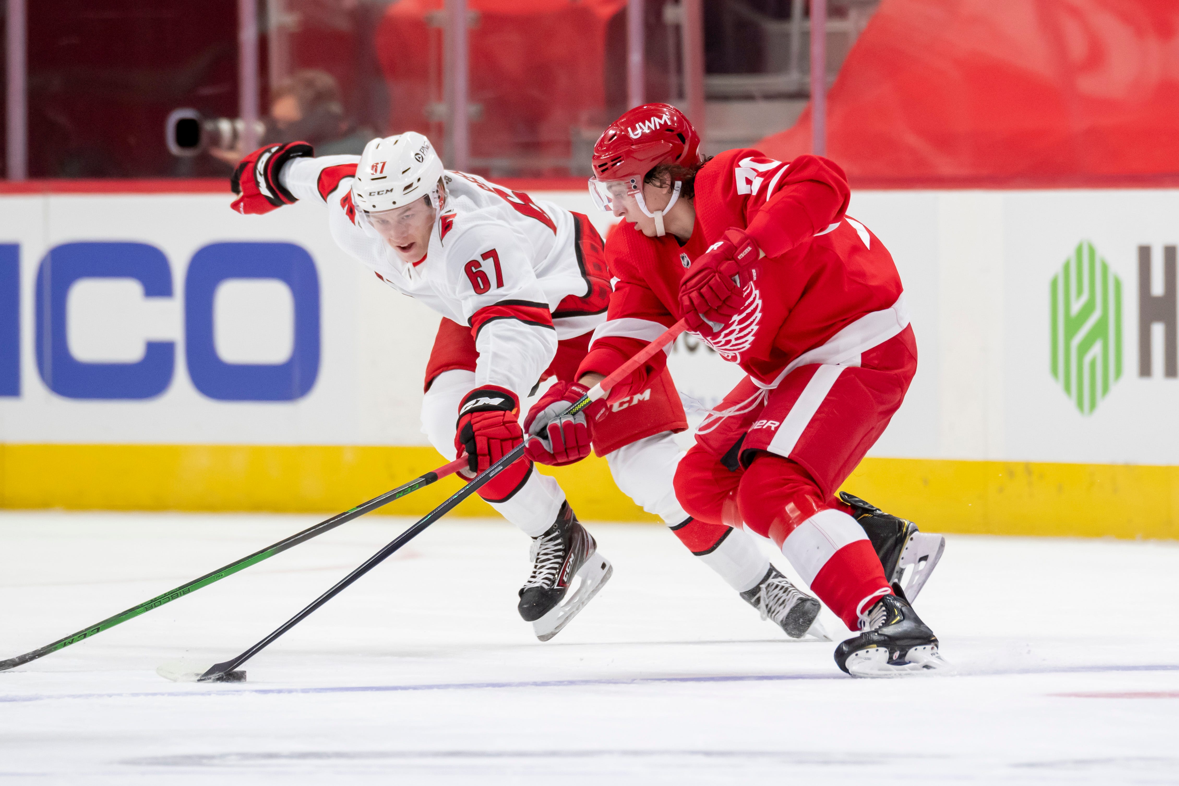 Detroit defenseman Troy Stecher keeps the puck away from Carolina center Morgan Geekie in the second period.
