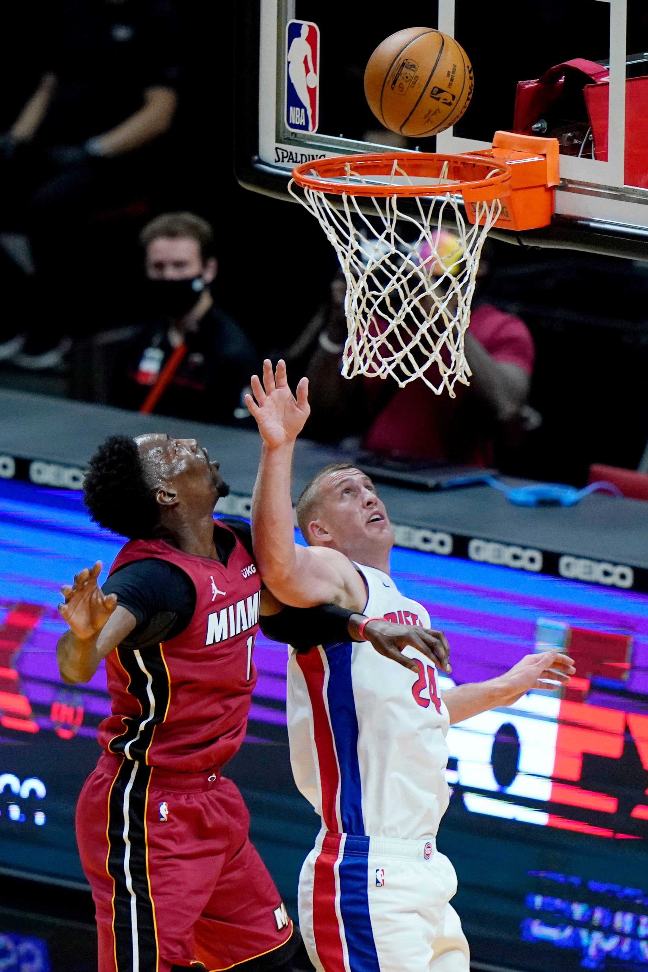 Miami Heat center Bam Adebayo, left, shoots over Detroit Pistons center Mason Plumlee (24) during the first half.