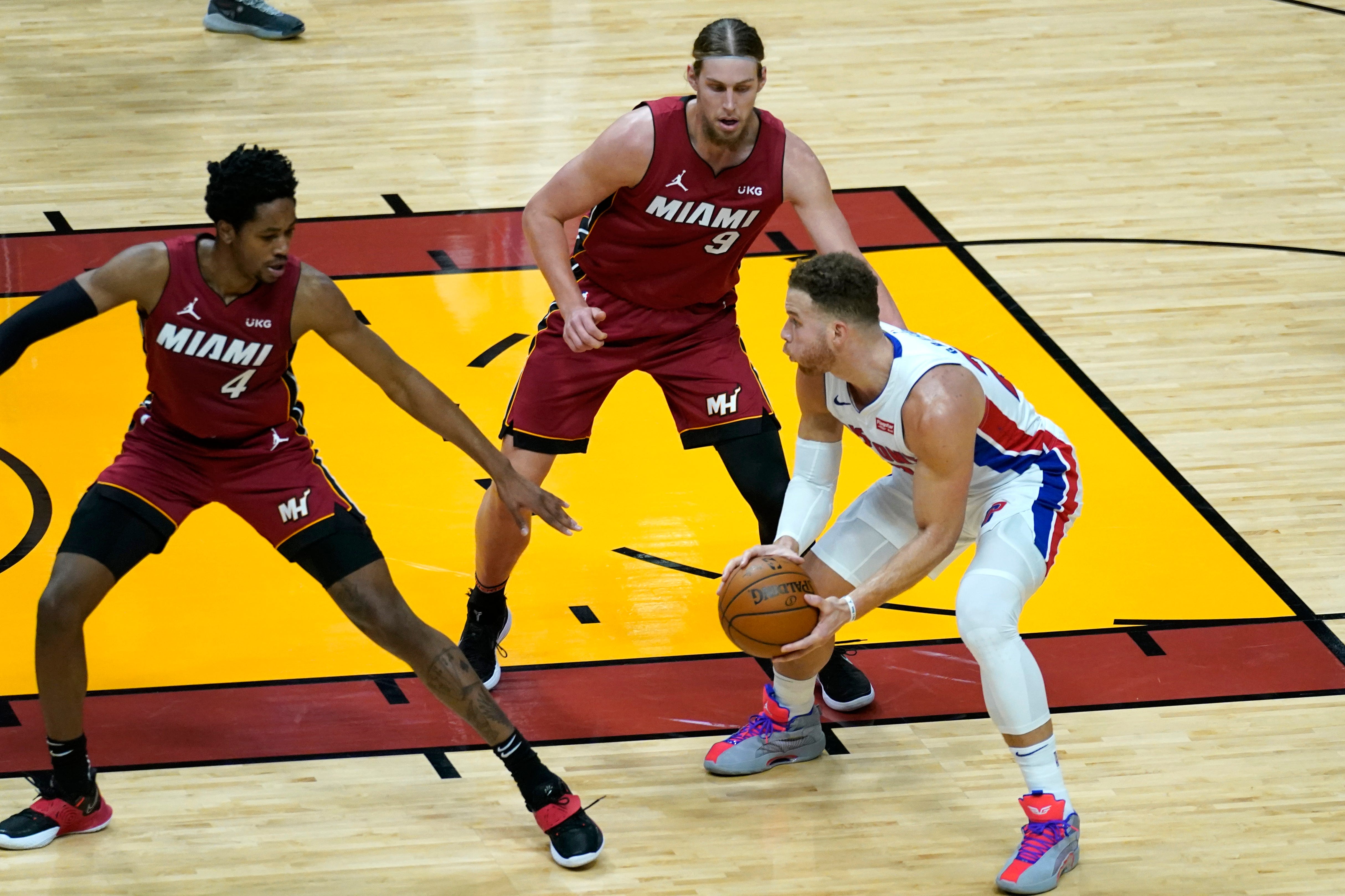Detroit Pistons forward Blake Griffin, right, drives to the basket as Miami Heat forward KZ Okpala (4) and forward Kelly Olynyk (9) defend during the first half.