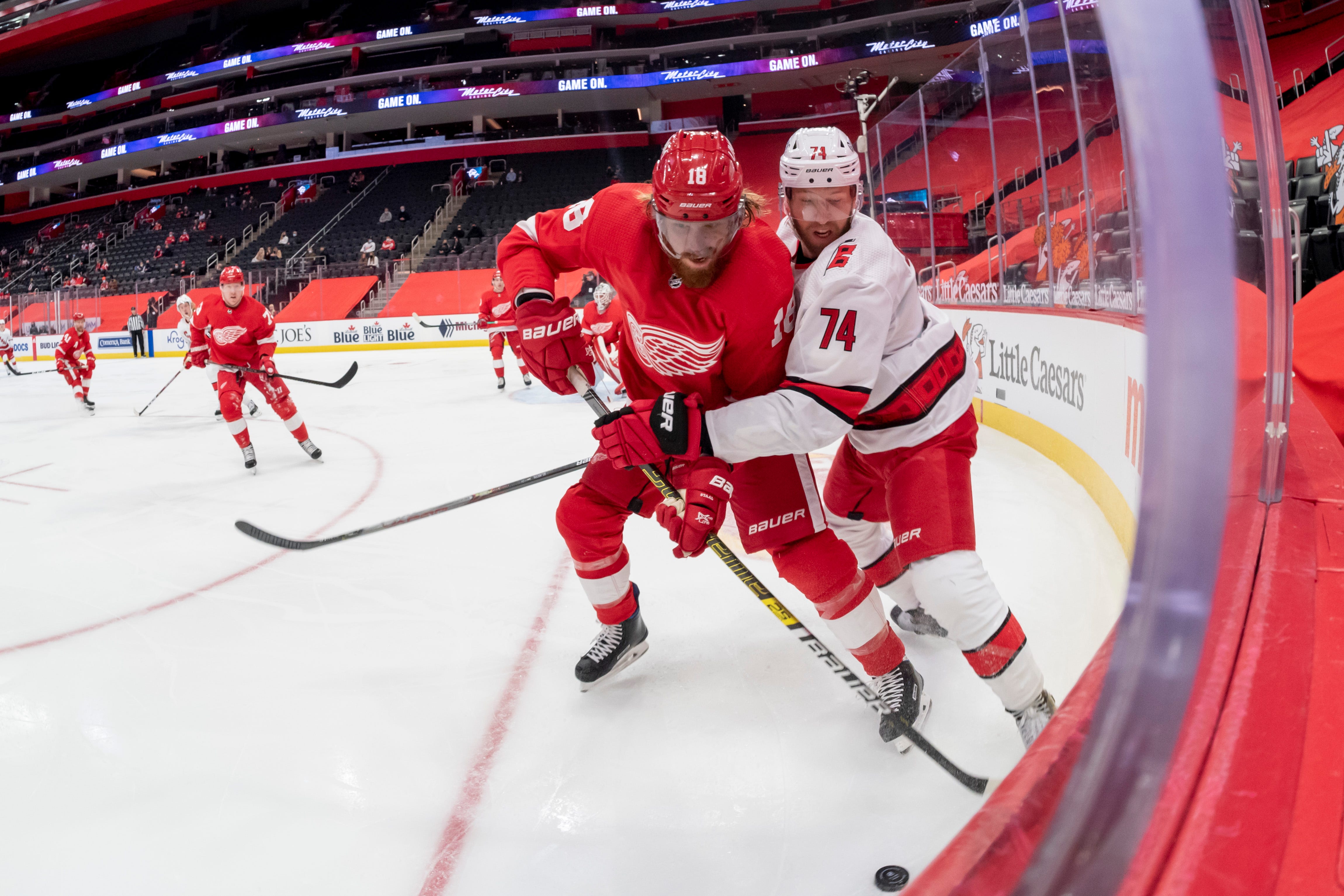 Detroit defenseman Marc Staal and Carolina defenseman Jaccob Slavin battle for the puck in the second period.