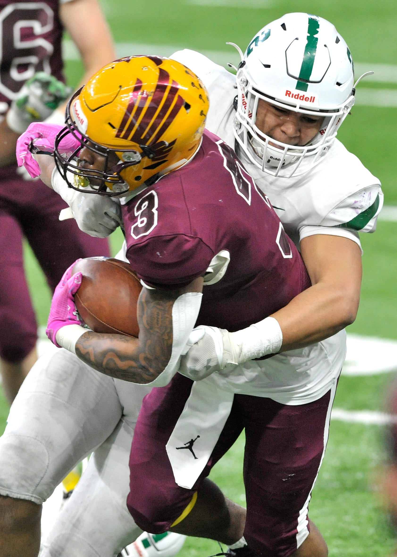Davison's TeAvion Warren (3) carries as he's tackled by West Bloomfield's Travis Reece (2) in the third quarter.