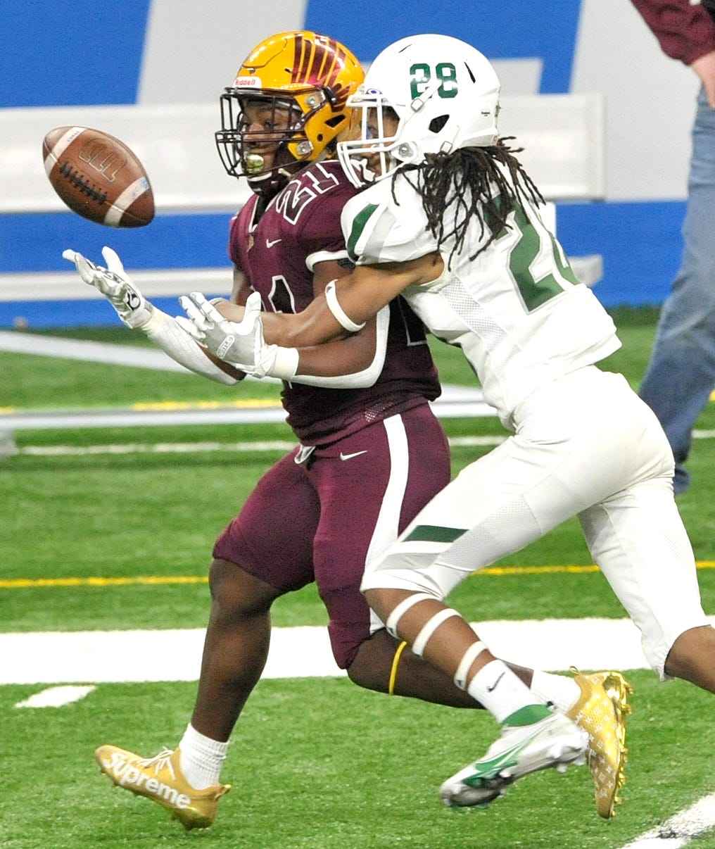 Davison's Jay'len Flowers (21) can't find the handle as he's covered by West Bloomfield's Travis Barnes (29) near the end of the fourth quarter during the MHSAA Division 1 finals at Ford Field on Saturday, January 23, 2021.