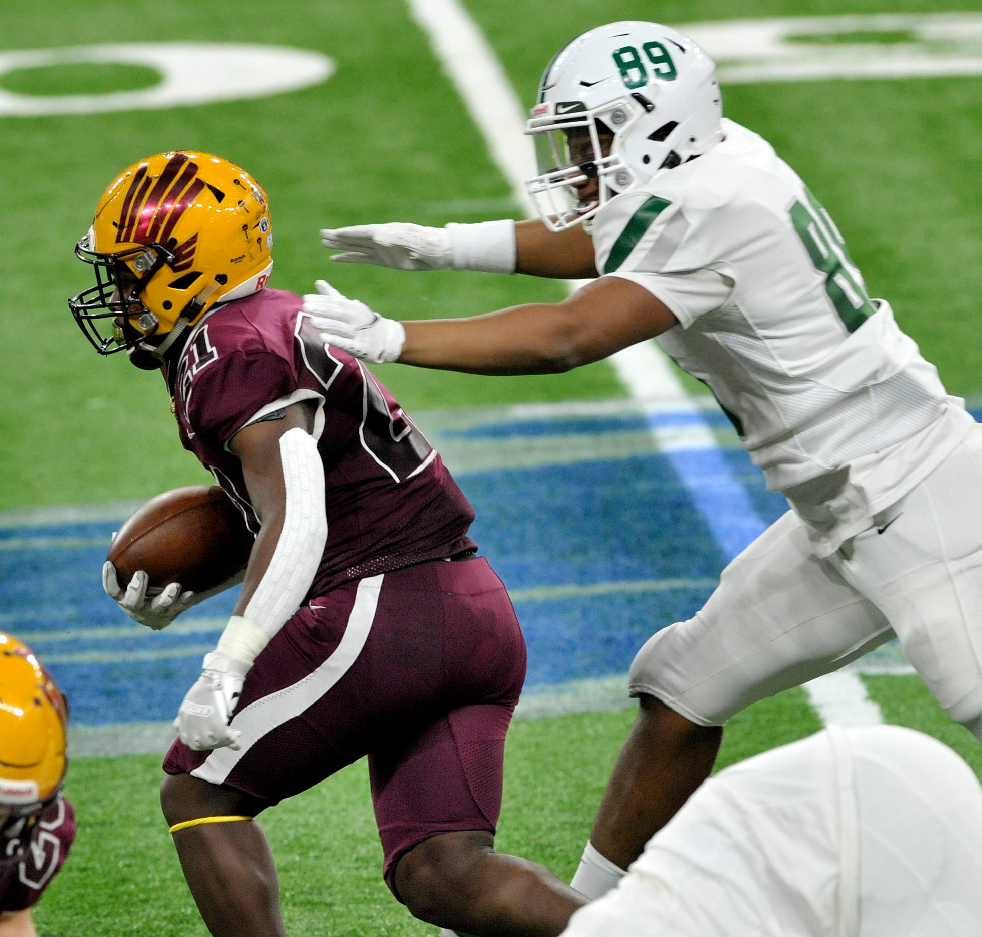 Davison's Jay'len Flowers (21) runs after catching a pass as he tackled by West Bloomfield's Brandon Davis Swain (89) near the end of the game.