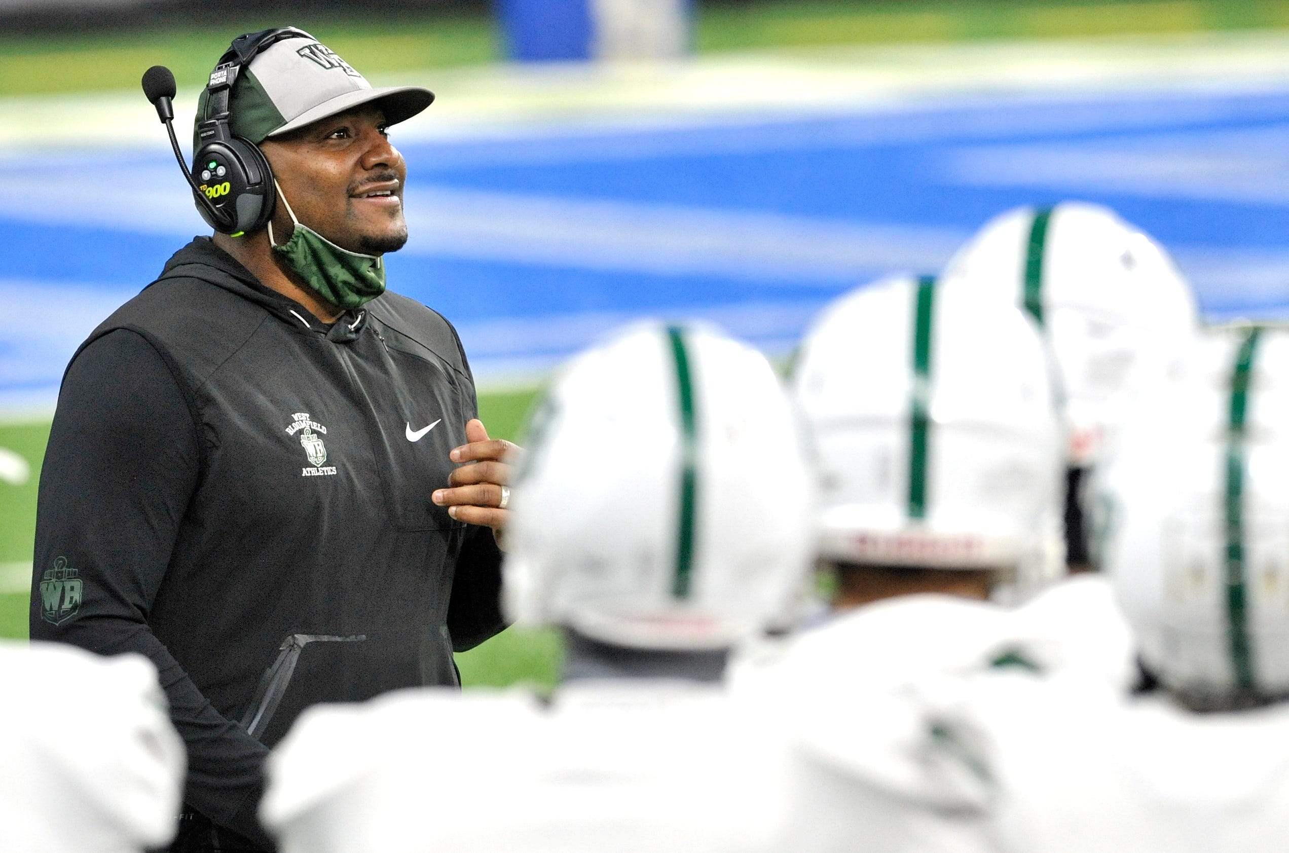 West Bloomfield head coach Ron Bellamy smiles after his team's sacks the Davison quarterback near the end of the third quarter.