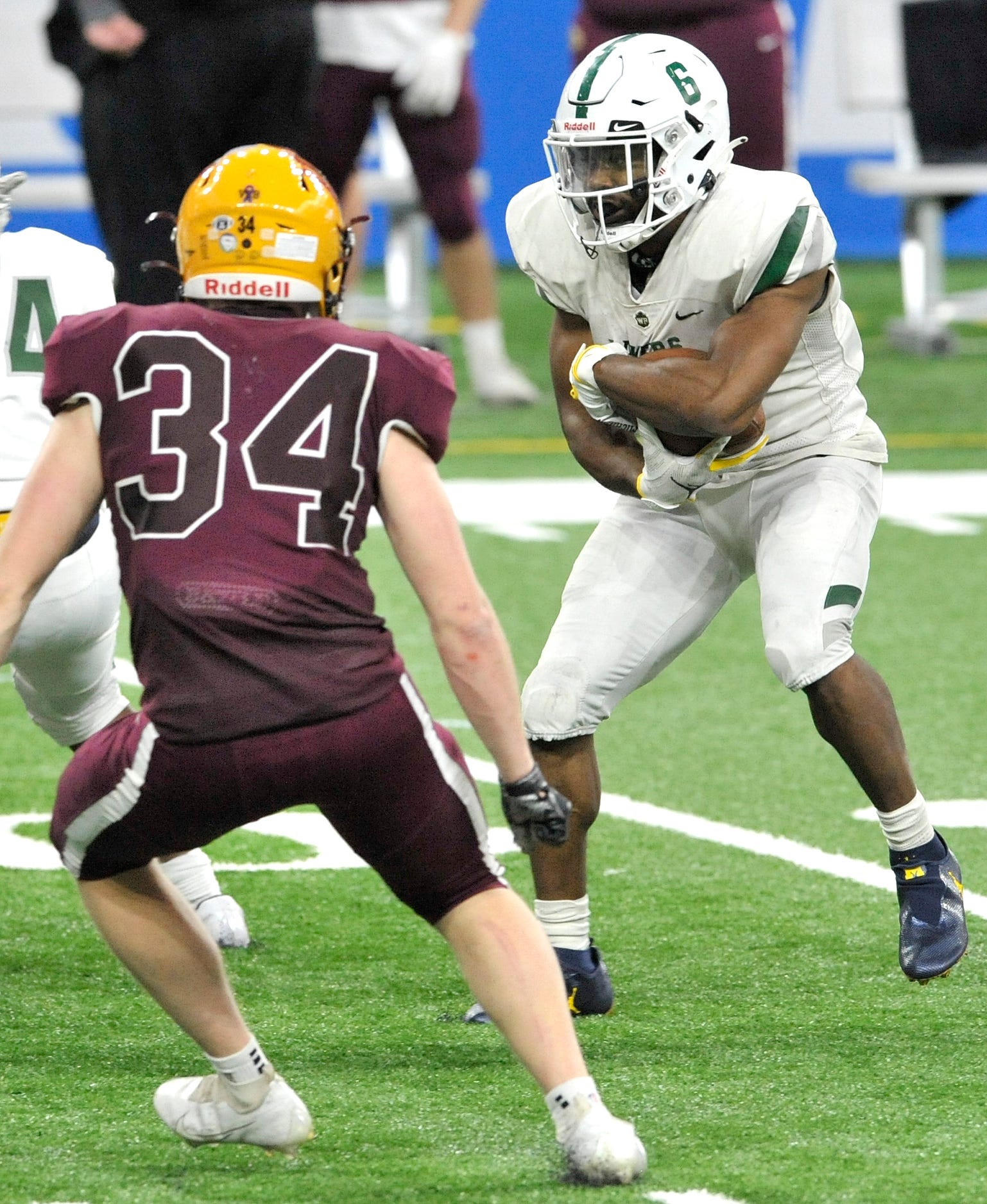 West Bloomfield's Donovan Edwards (6) protects the ball near the end of the third quarter as Davison's Payton Pizzala (34) closes in.