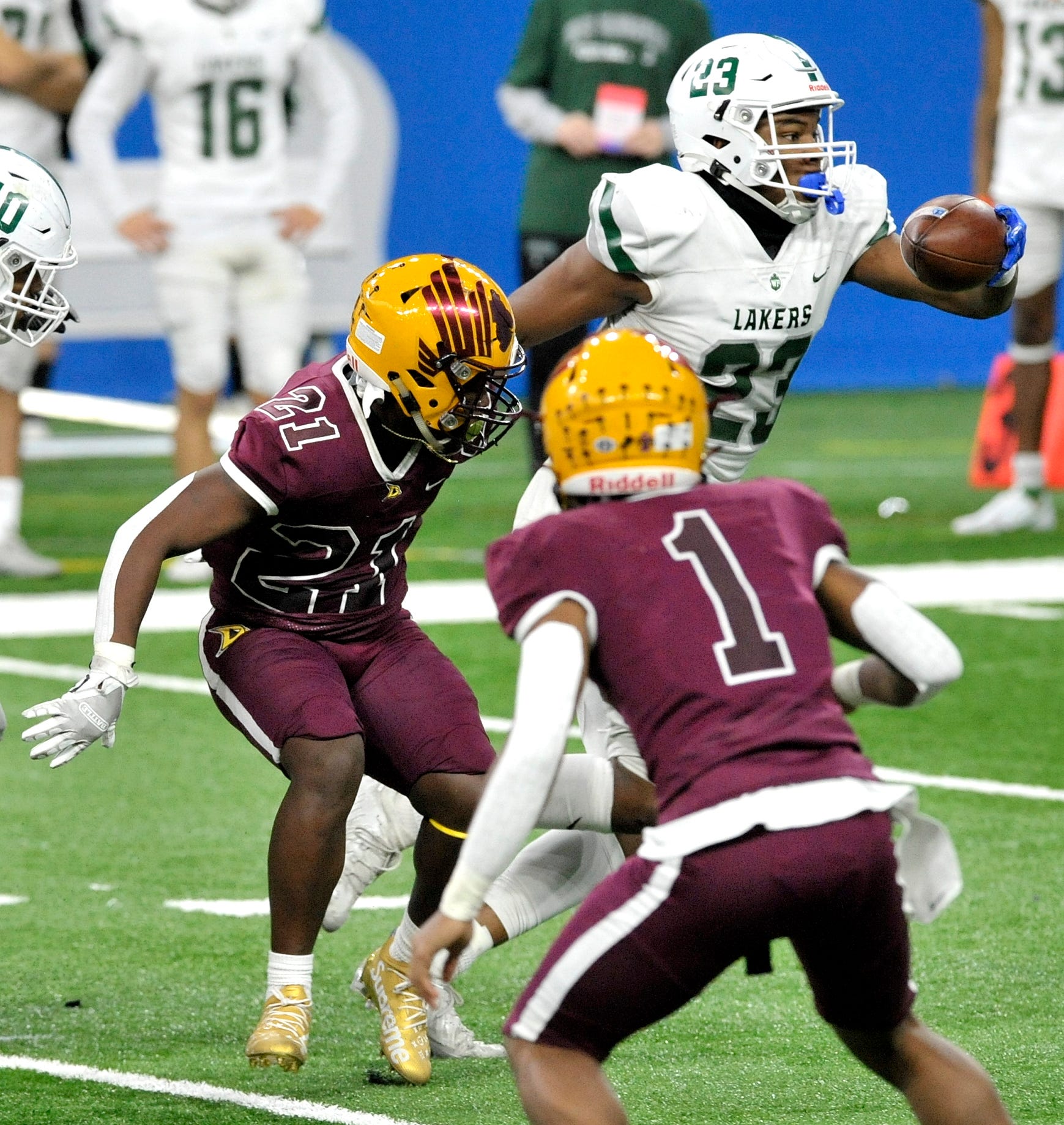 West Bloomfield's Niles King (23) strips the ball from Davison's Jayâlen Flowers (21) early in the 3rd quarter and runs for a WB touchdown.