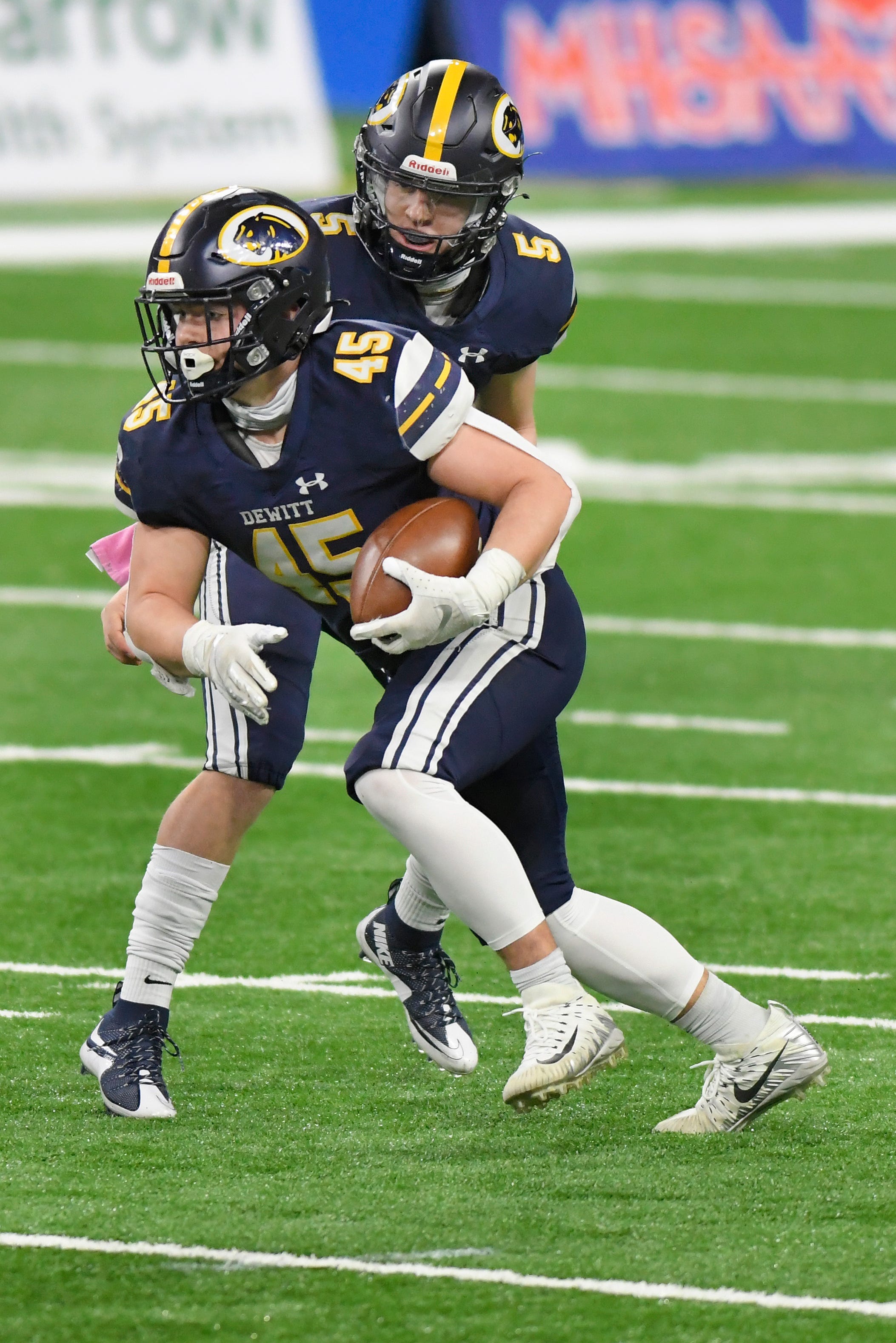 DeWitt running back Andrew Debri rushes against River Rouge in the first quarter of a Division 3 football final.