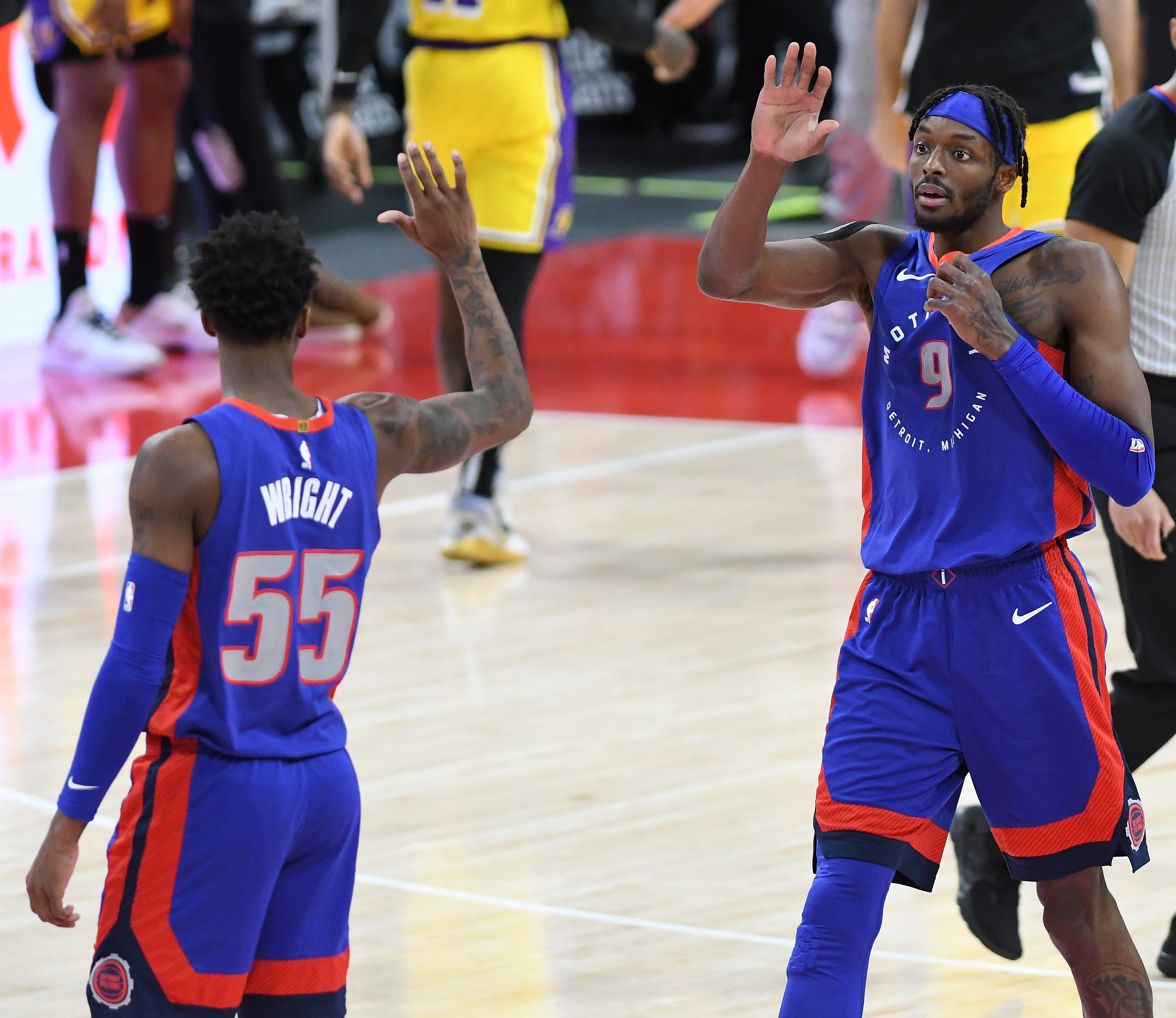 Pistons Jerami Grant, left, celebrates the win with Delon Wright late in the fourth quarter.