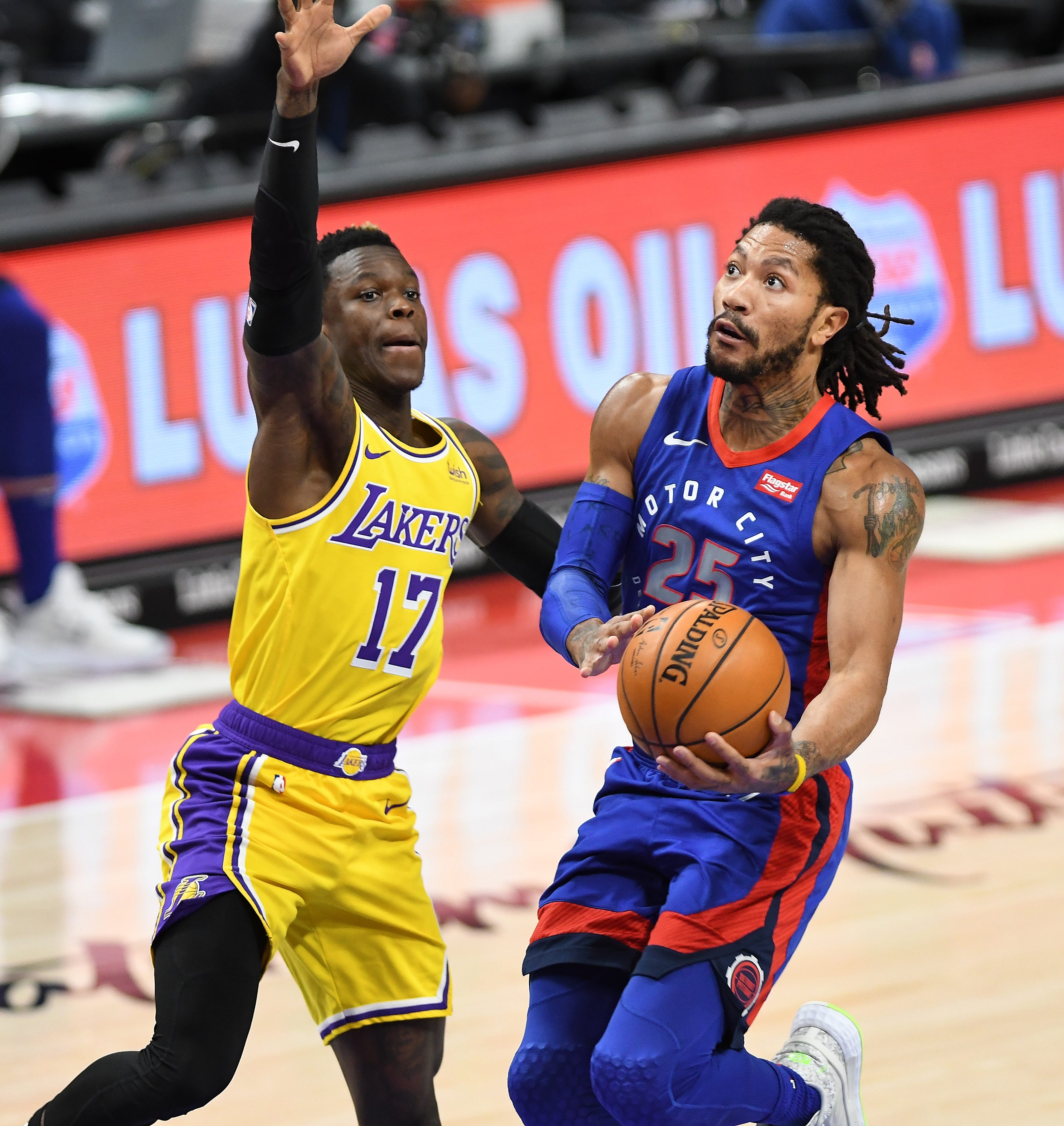 Pistons' Derrick Rose scores over Lakers' Dennis Schroder in the second quarter.