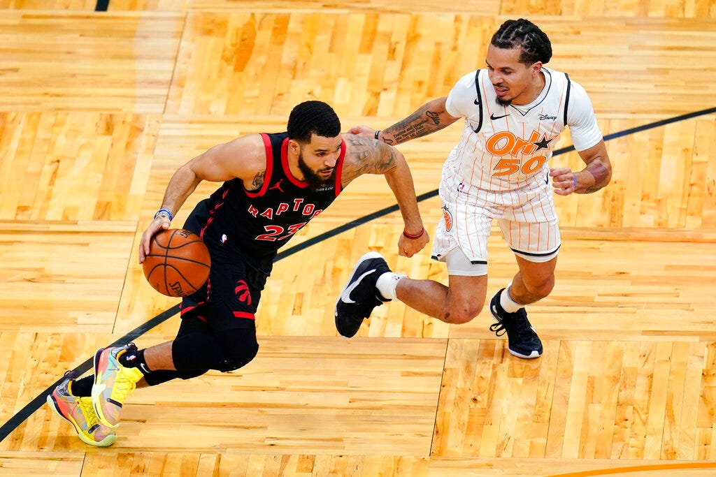 Toronto Raptors guard Fred VanVleet, left, drives around Orlando Magic guard Cole Anthony (50) during the first half Tuesday.