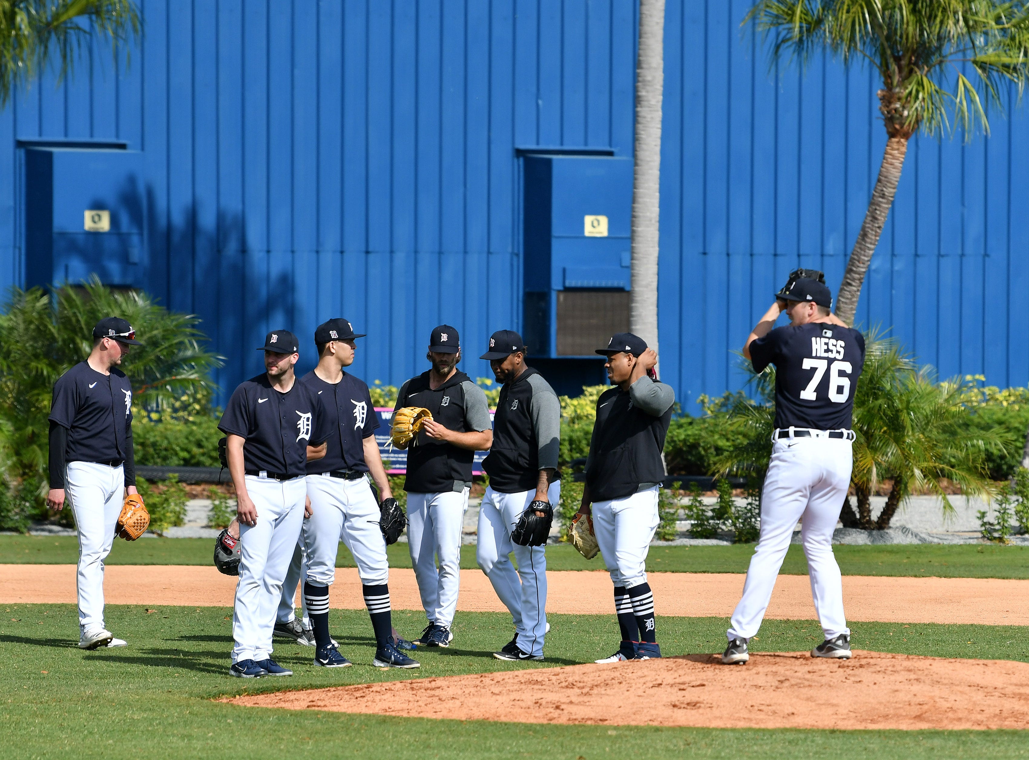 Tigers pitcher wait their turn as Zack Hess (76) goes through an infield drill.