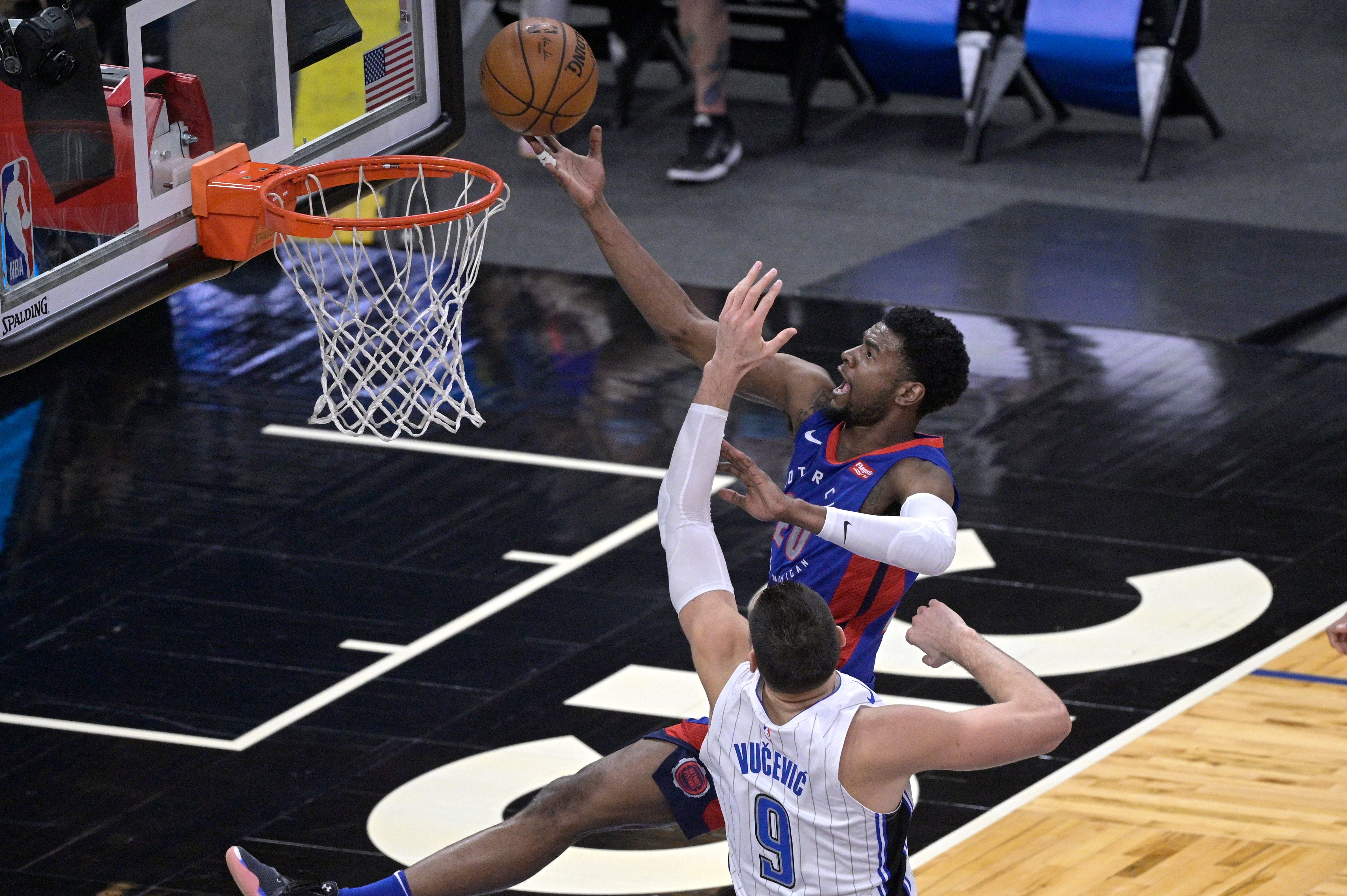 Detroit Pistons guard Josh Jackson (20) goes up for a shot in front of Orlando Magic center Nikola Vucevic (9) during the second half of an NBA basketball game.