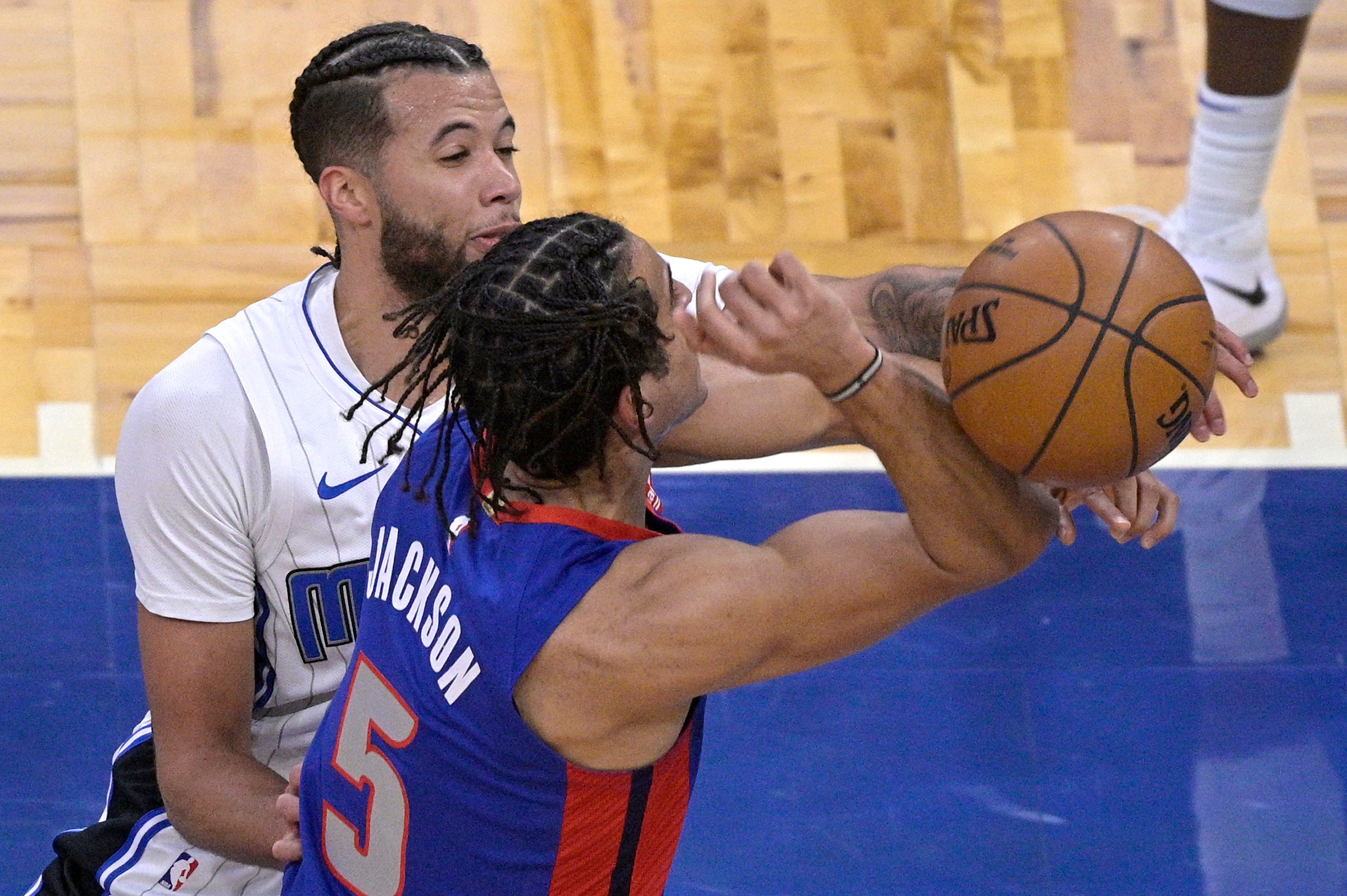 Orlando Magic guard Michael Carter-Williams (7) knocks the ball out of the hands of Detroit Pistons guard Frank Jackson (5) who was going up for a shot during the first half of an NBA basketball game, Tuesday, Feb. 23, 2021.