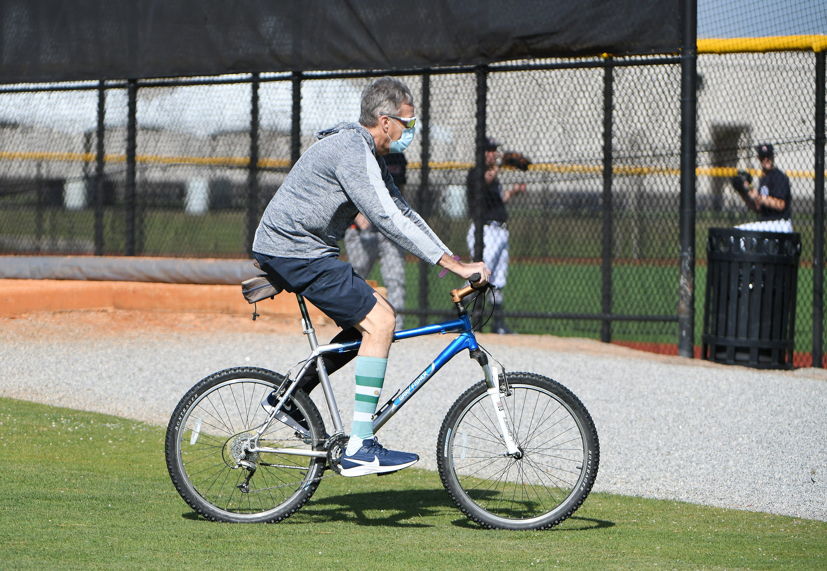 Clubhouse manager Jim Schmakel rides his bicycle to get where he needs to go on the practice fields.