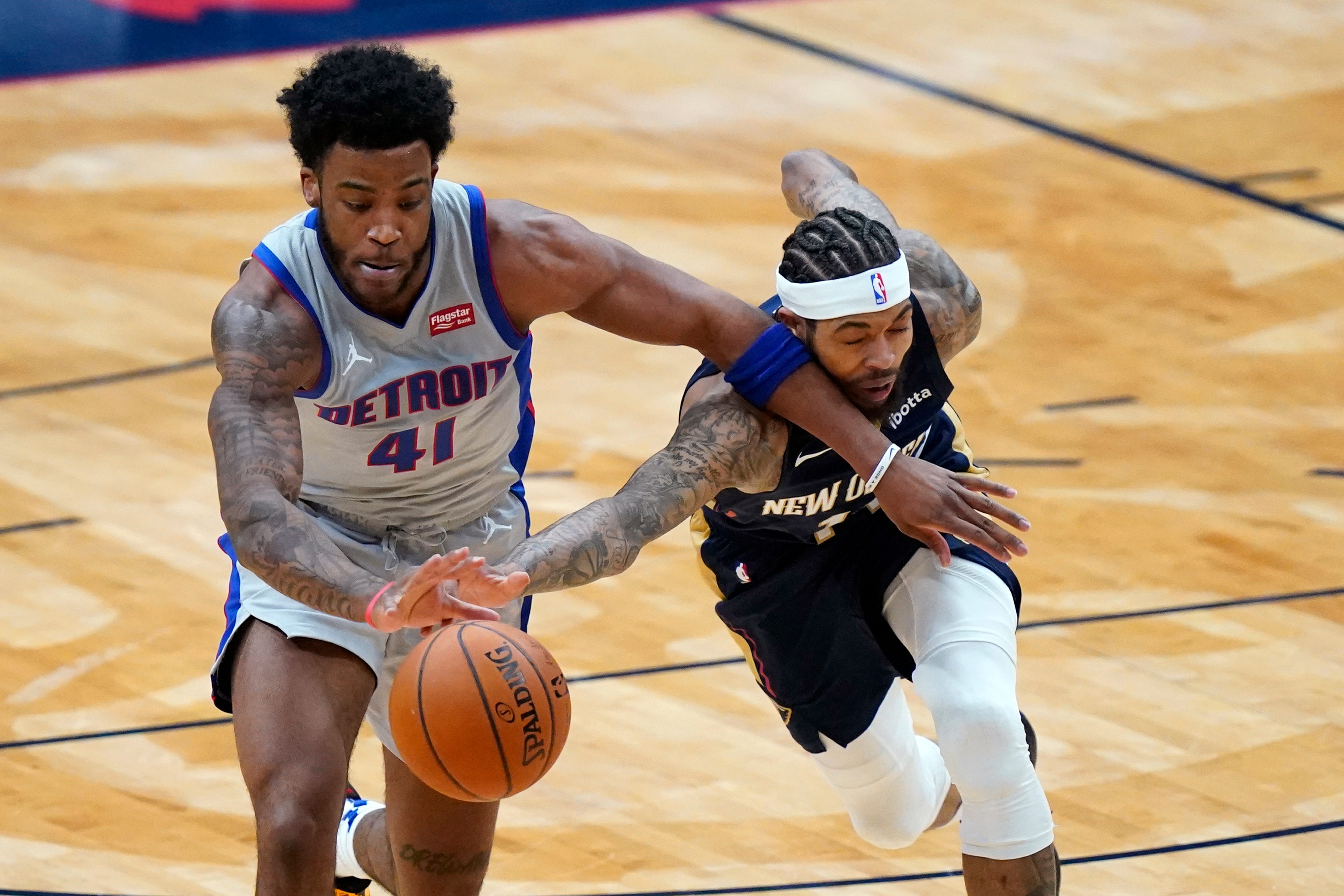 Detroit Pistons forward Saddiq Bey (41) and New Orleans Pelicans forward Brandon Ingram reach for the ball during the first half of an NBA basketball game in New Orleans, Wednesday, Feb. 24, 2021.
