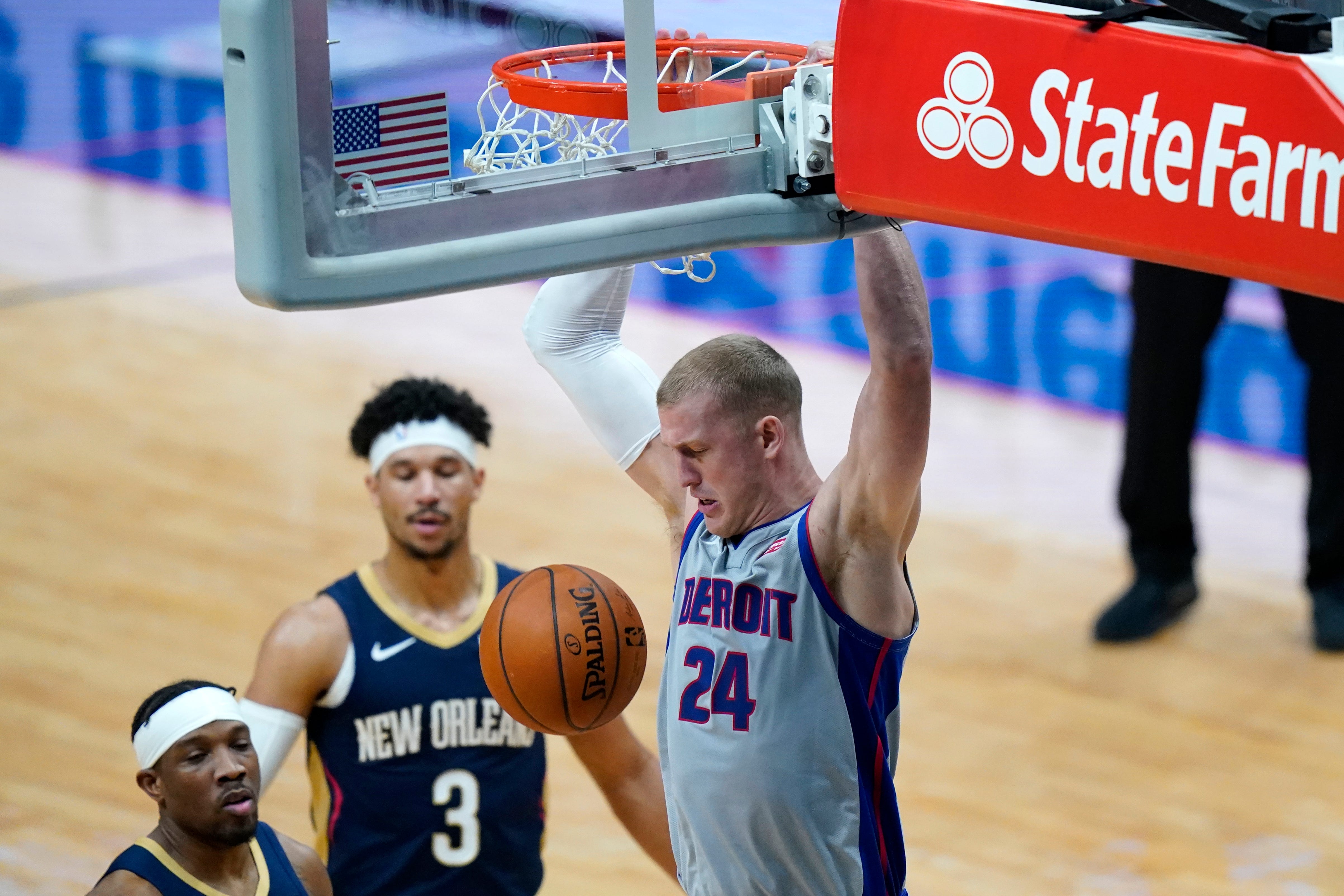 Detroit Pistons center Mason Plumlee (24) dunks next to New Orleans Pelicans guards Eric Bledsoe and Josh Hart (3) during the first half of an NBA basketball game in New Orleans, Wednesday, Feb. 24, 2021.