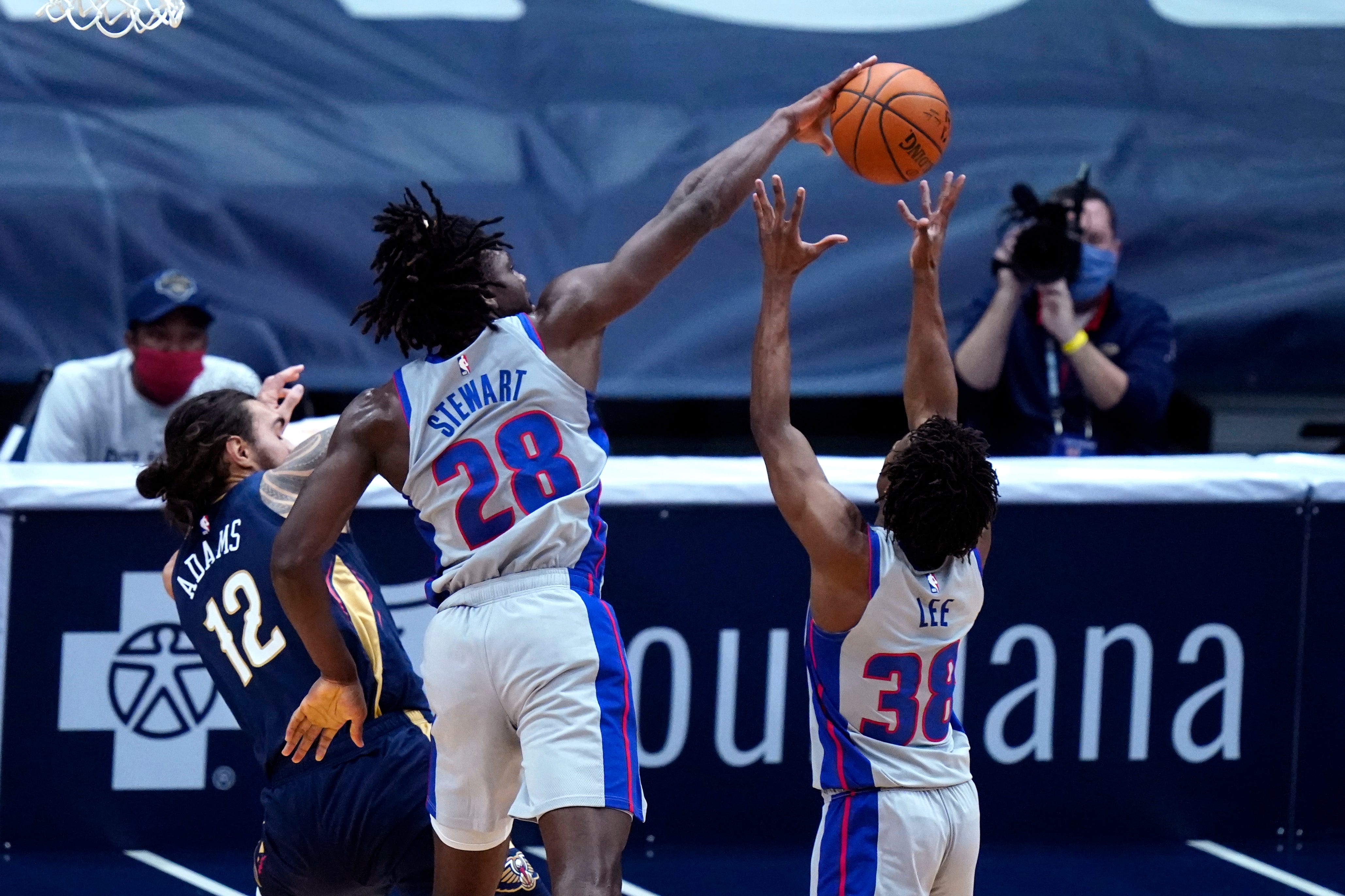 Detroit Pistons center Isaiah Stewart (28) and guard Saben Lee (38) and New Orleans Pelicans center Steven Adams (12) look for a rebound during the first half of an NBA basketball game in New Orleans, Wednesday, Feb. 24, 2021.