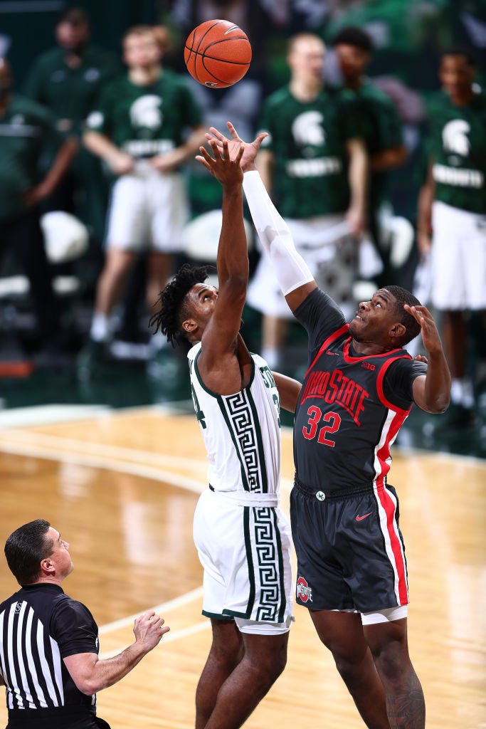 Julius Marble II (34) of the Michigan State Spartans and E.J. Liddell (32) of the Ohio State Buckeyes tip off the game.