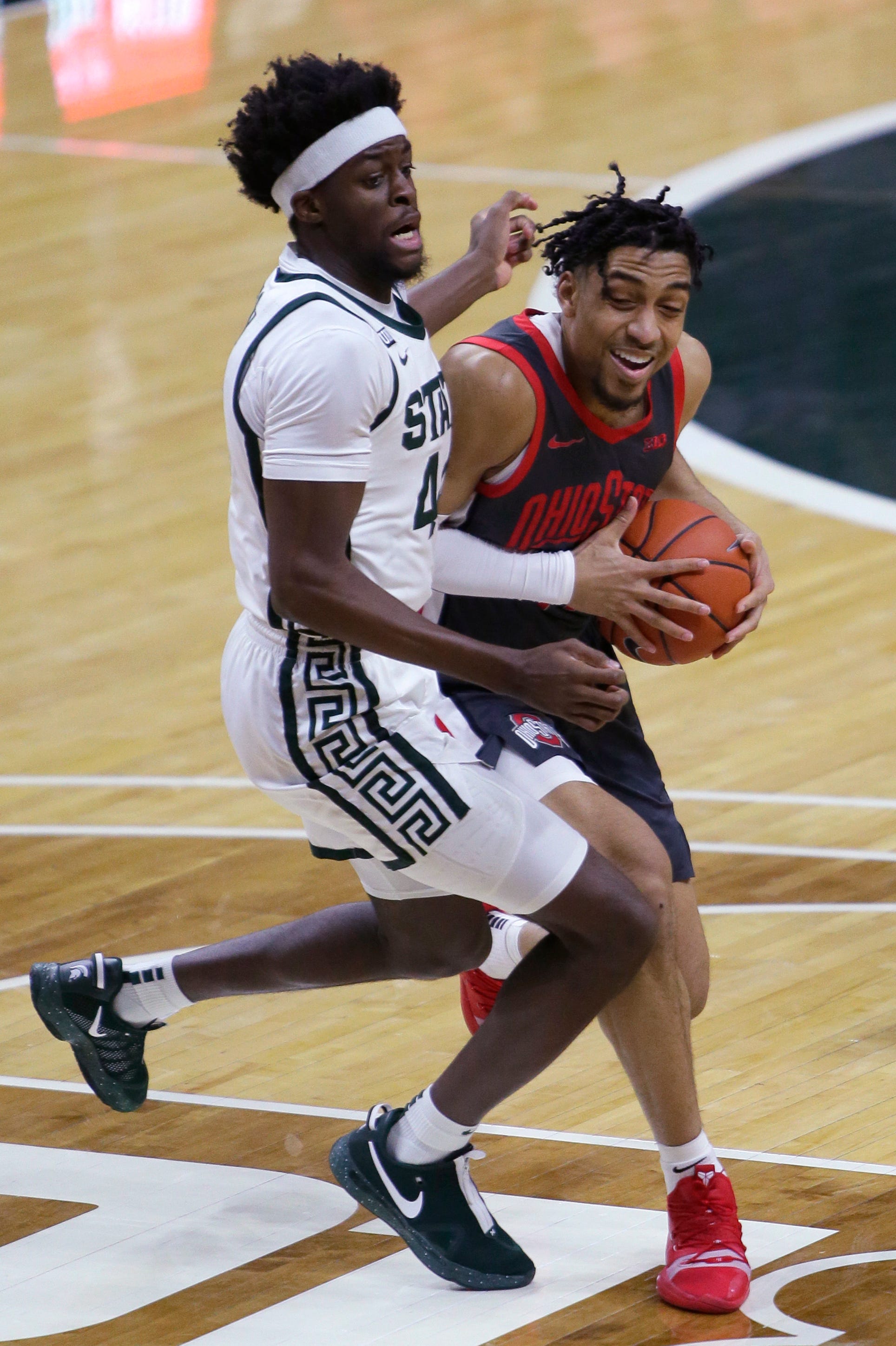 Ohio State forward Justice Sueing, right, is guarded by Michigan State forward Gabe Brown during the first half.