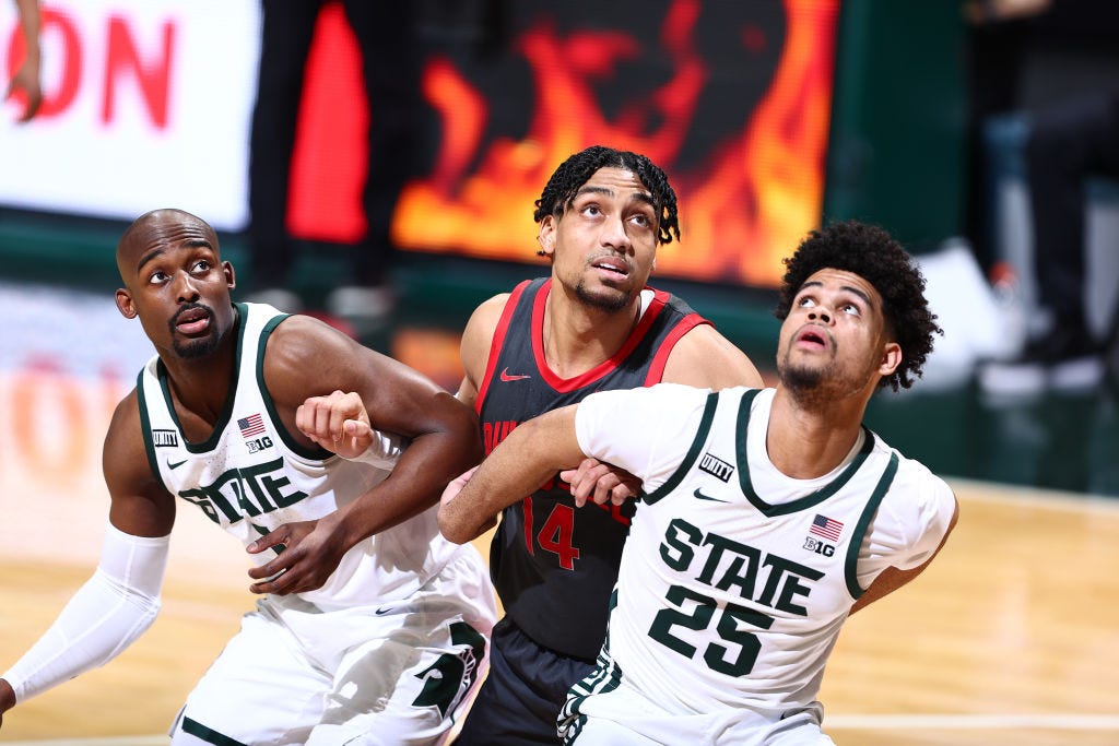 Malik Hall (25) and Joshua Langford (1) of the Michigan State Spartans boxout Justice Sueing (14) of the Ohio State Buckeyes in the second half.