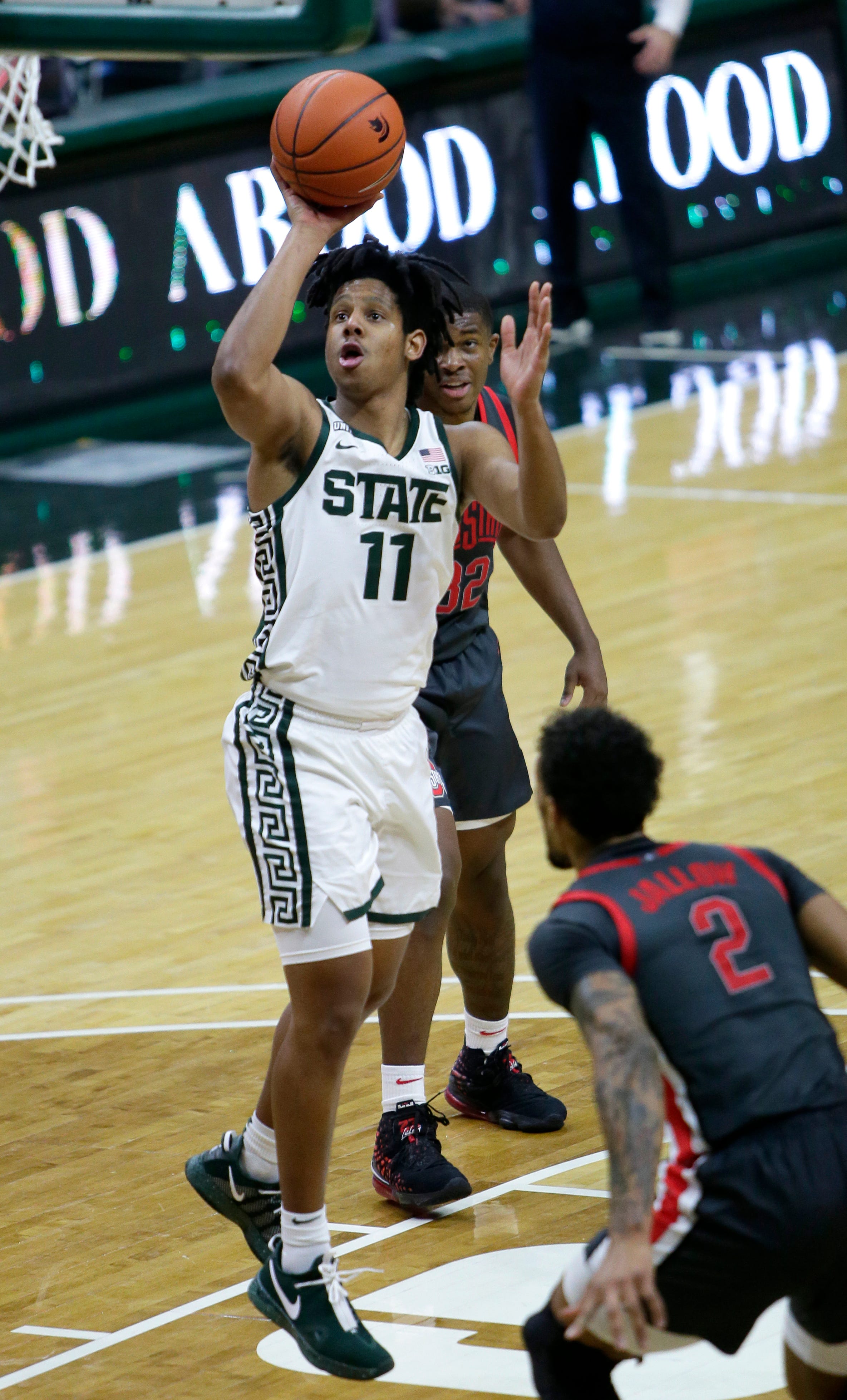 Michigan State guard A.J. Hoggard (11) shoots next to Ohio State forward E.J. Liddell (32) and guard Musa Jallow (2) during the second half.