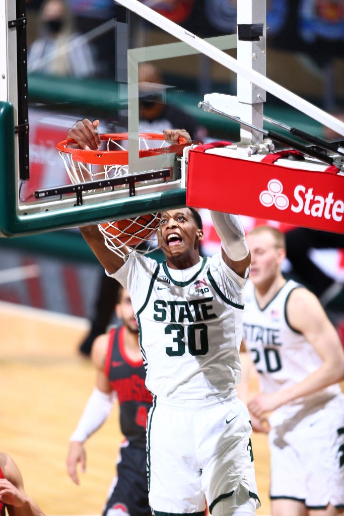 Marcus Bingham Jr. (30) of the Michigan State Spartans dunks the ball in the first half.
