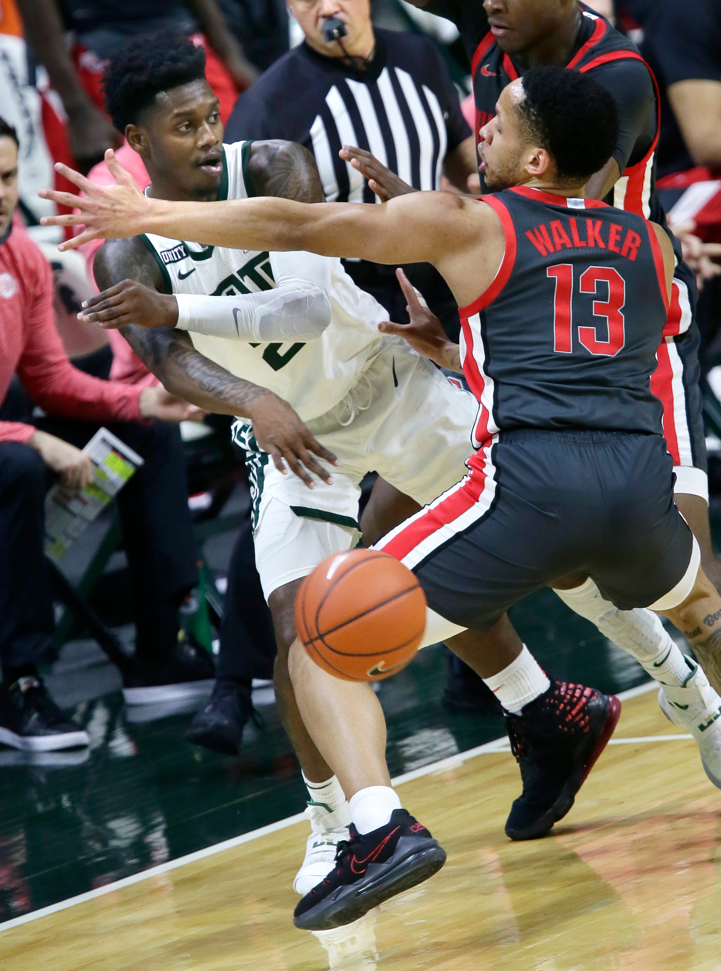 Michigan State guard Rocket Watts (2) passes the ball past Ohio State guard CJ Walker (13) during the first half.
