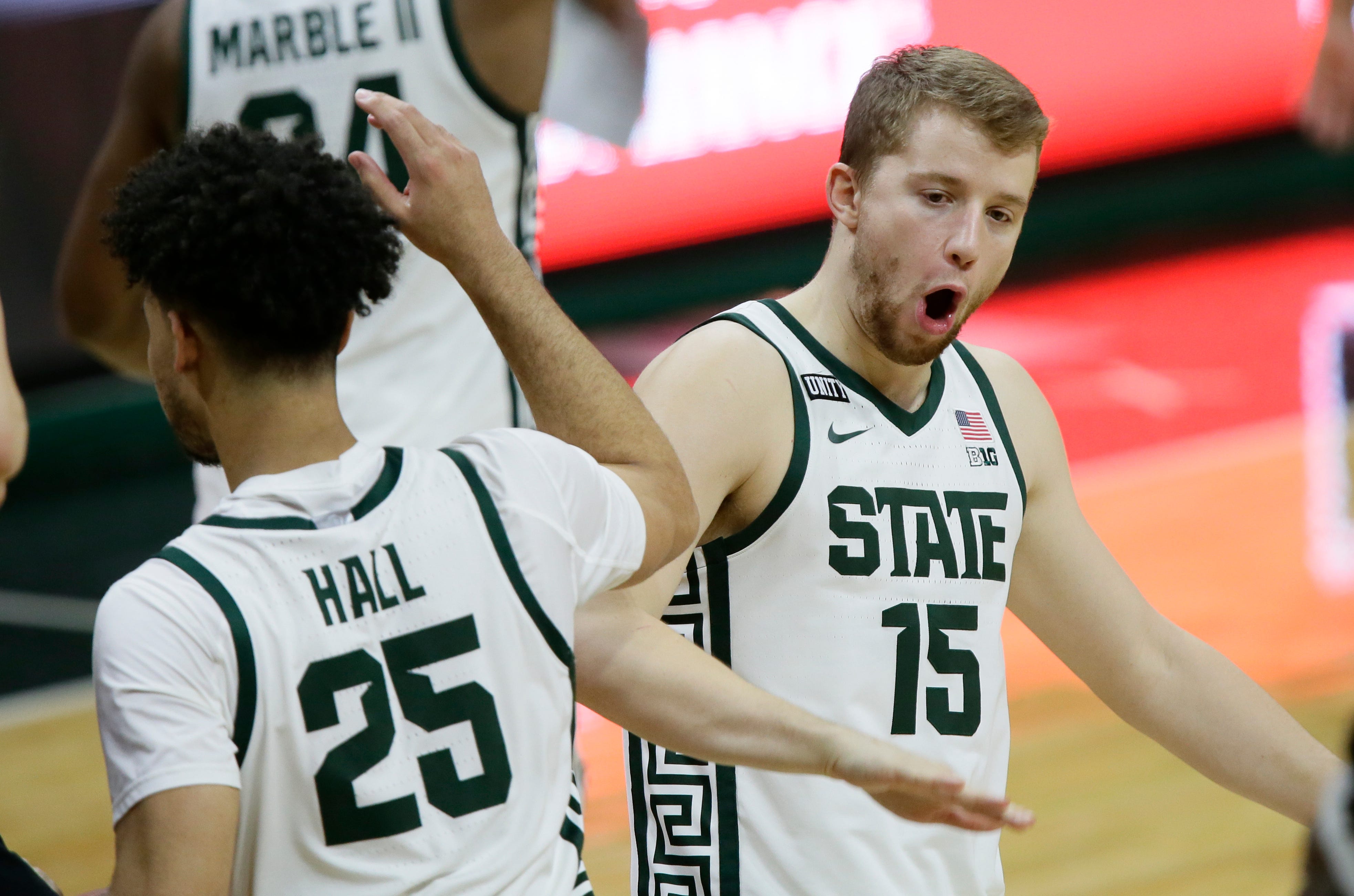 Michigan State forward Thomas Kithier (15) celebrates with forward Malik Hall (25) after a win over Ohio State in an NCAA college basketball game Thursday, Feb. 25, 2021, in East Lansing, Mich.