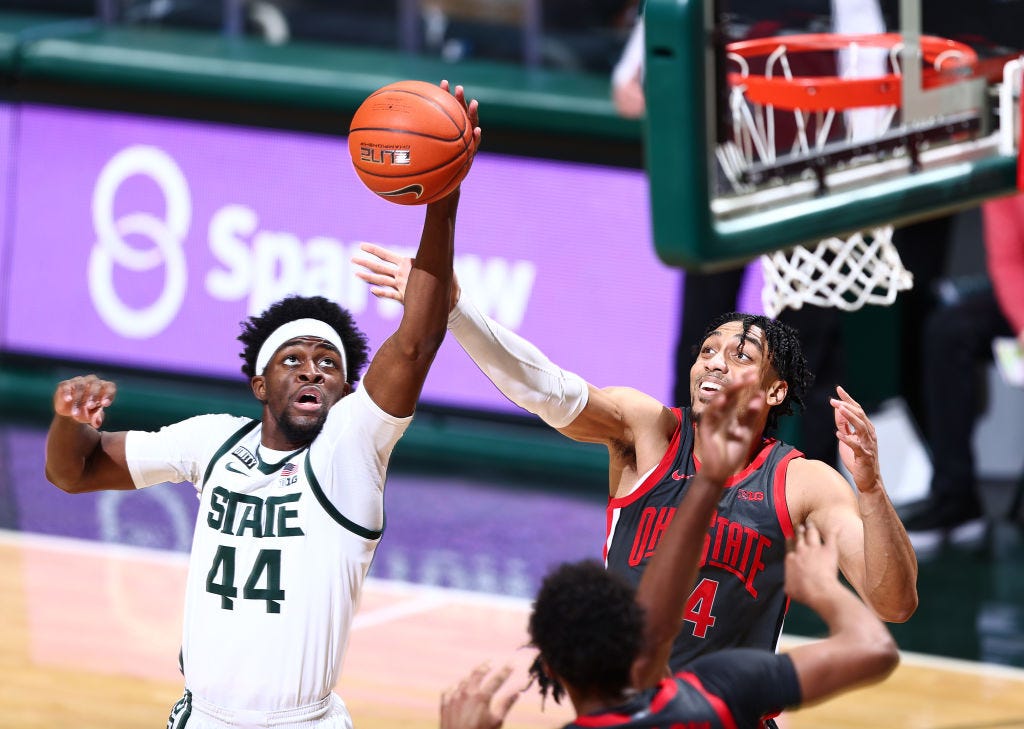 Gabe Brown (44) of the Michigan State Spartans grabs a rebound against Justice Sueing (14) of the Ohio State Buckeyes in the second half.