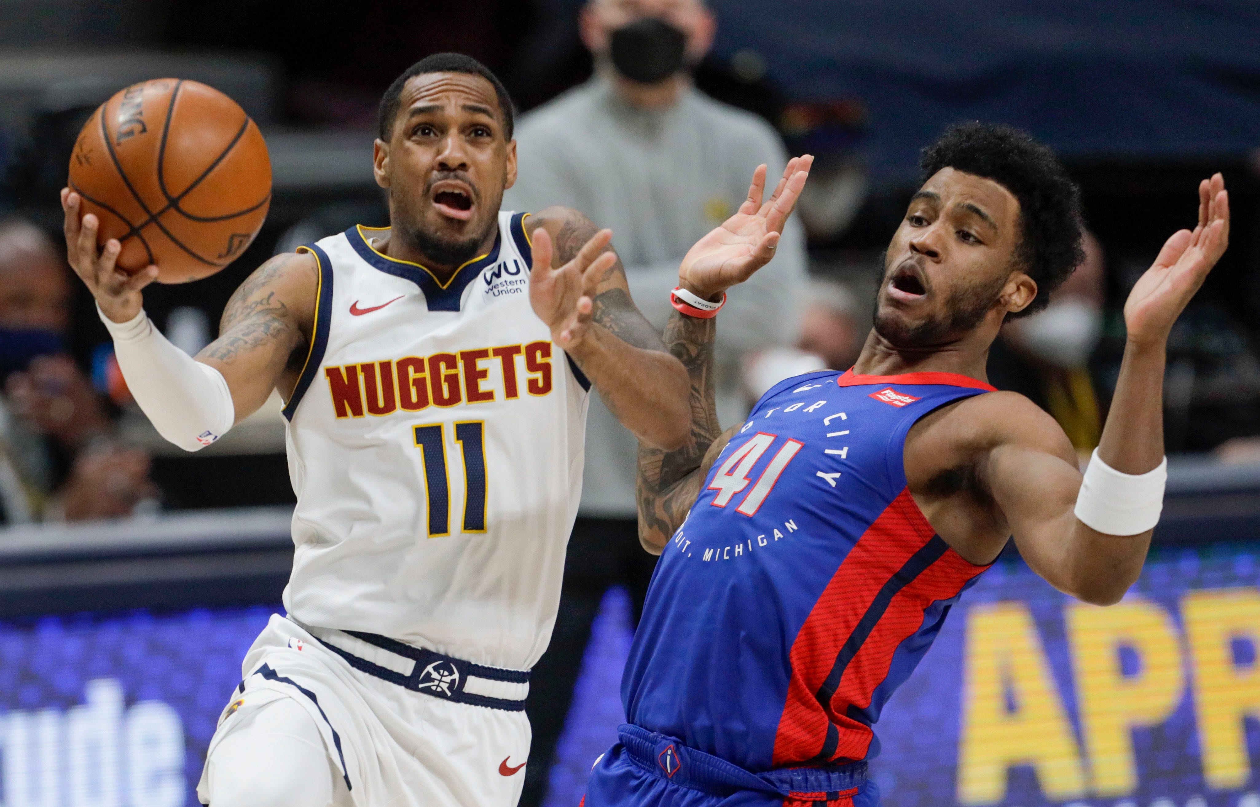 Denver Nuggets guard Monte Morris (11) drives to the basket against Detroit Pistons forward Saddiq Bey (41) in the second quarter of an NBA basketball game in Denver, Tuesday, April 6, 2021.