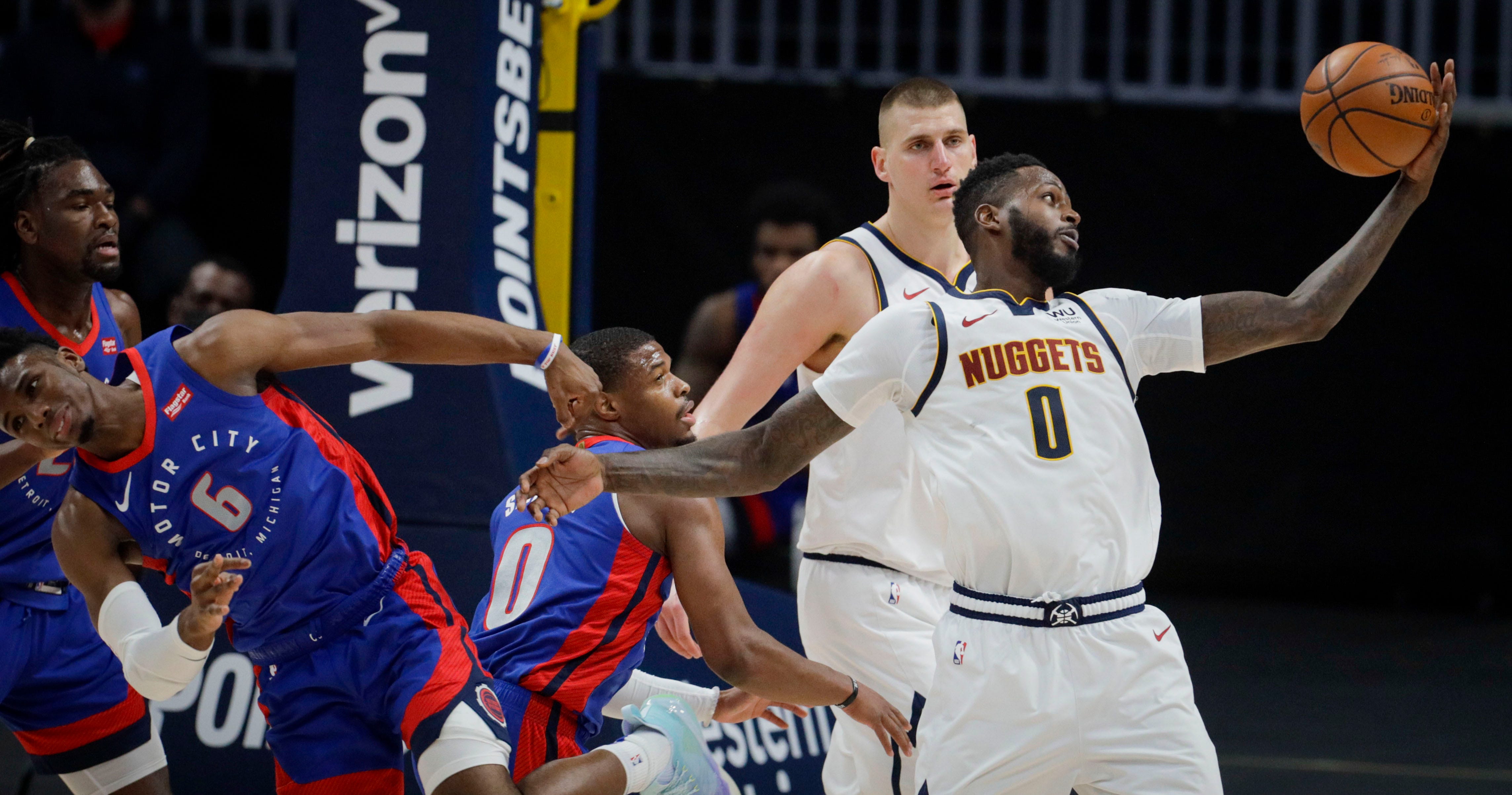 Denver Nuggets forward JaMychal Green, right, pulls in a loose ball against Detroit Pistons guards Dennis Smith Jr. (0) and Hamidou Diallo (6) as Nuggets center Nikola Jokic (15) watches in the third quarter of an NBA basketball game in Denver, Tuesday, April 6, 2021.