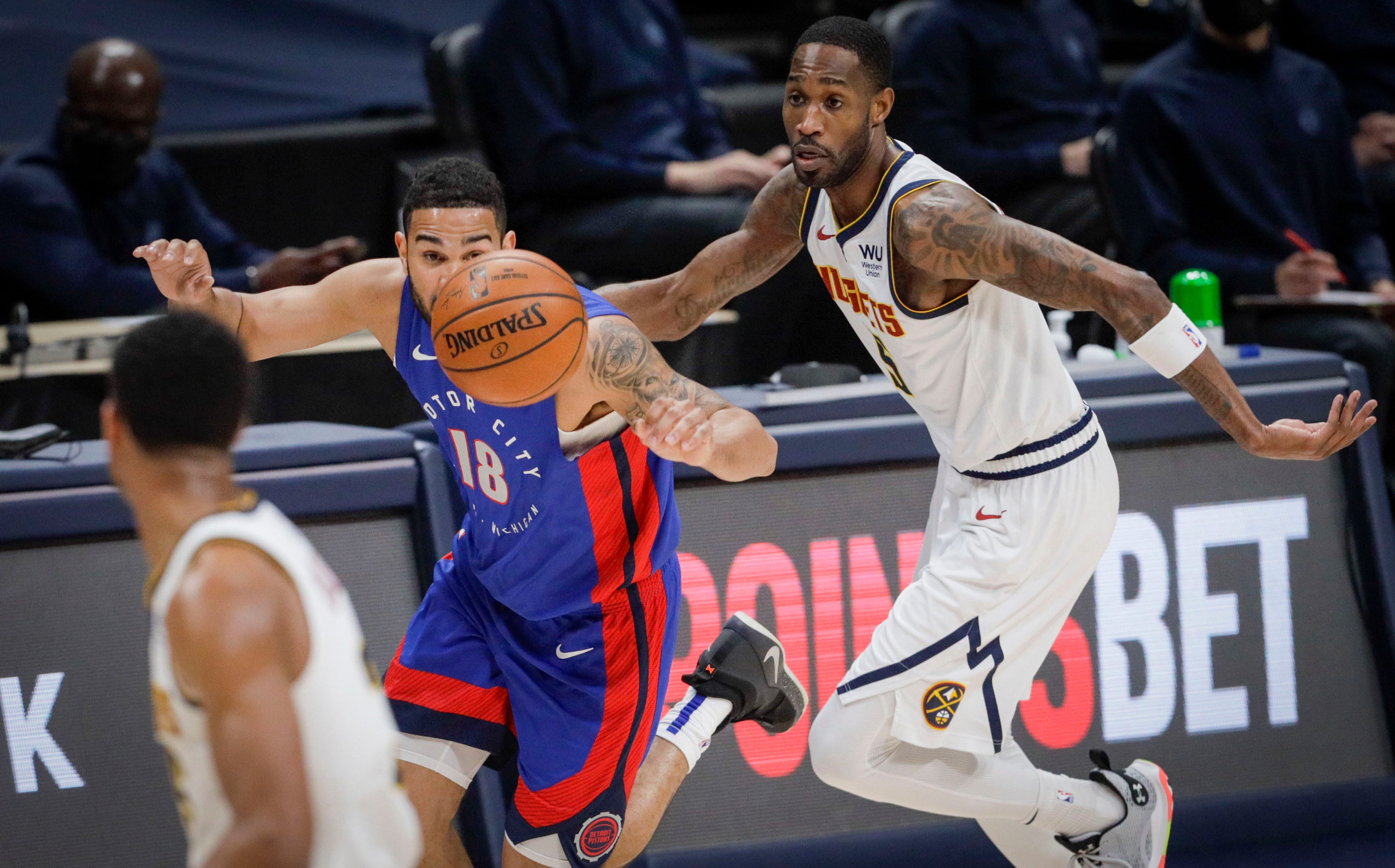 Detroit Pistons guard Cory Joseph (18) dribbles past Denver Nuggets forward Will Barton (5) in the fourth quarter of an NBA basketball game in Denver, Tuesday, April 6, 2021. Denver won 134-119.