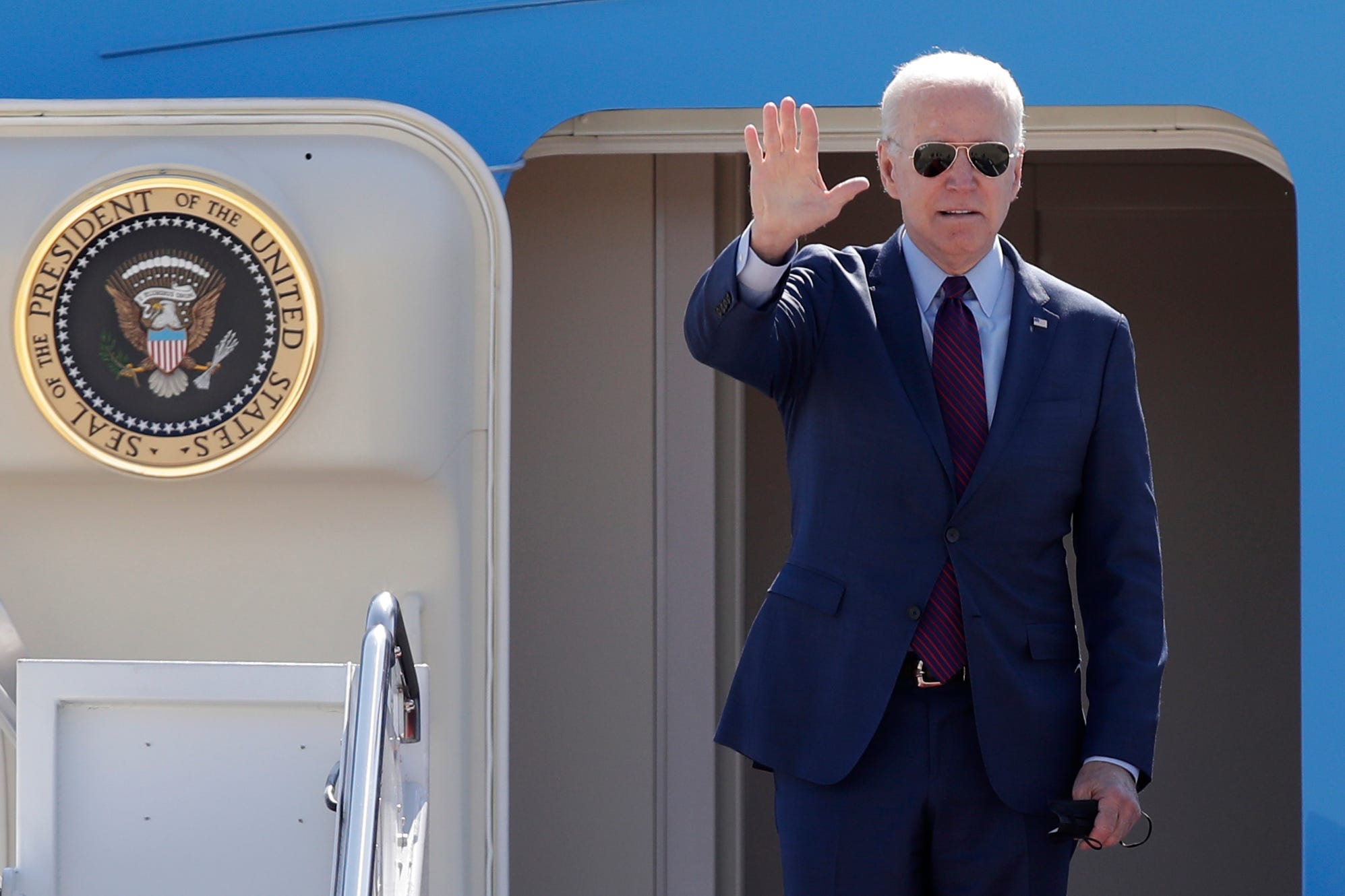 President Joe Biden waves from the stairs of Air Force One at Andrews Air Force Base, Md., Tuesday, May 18, 2021, on his departure and then on to Detroit to visit the Ford Rouge Electric Vehicle Center in Dearborn, Mich.