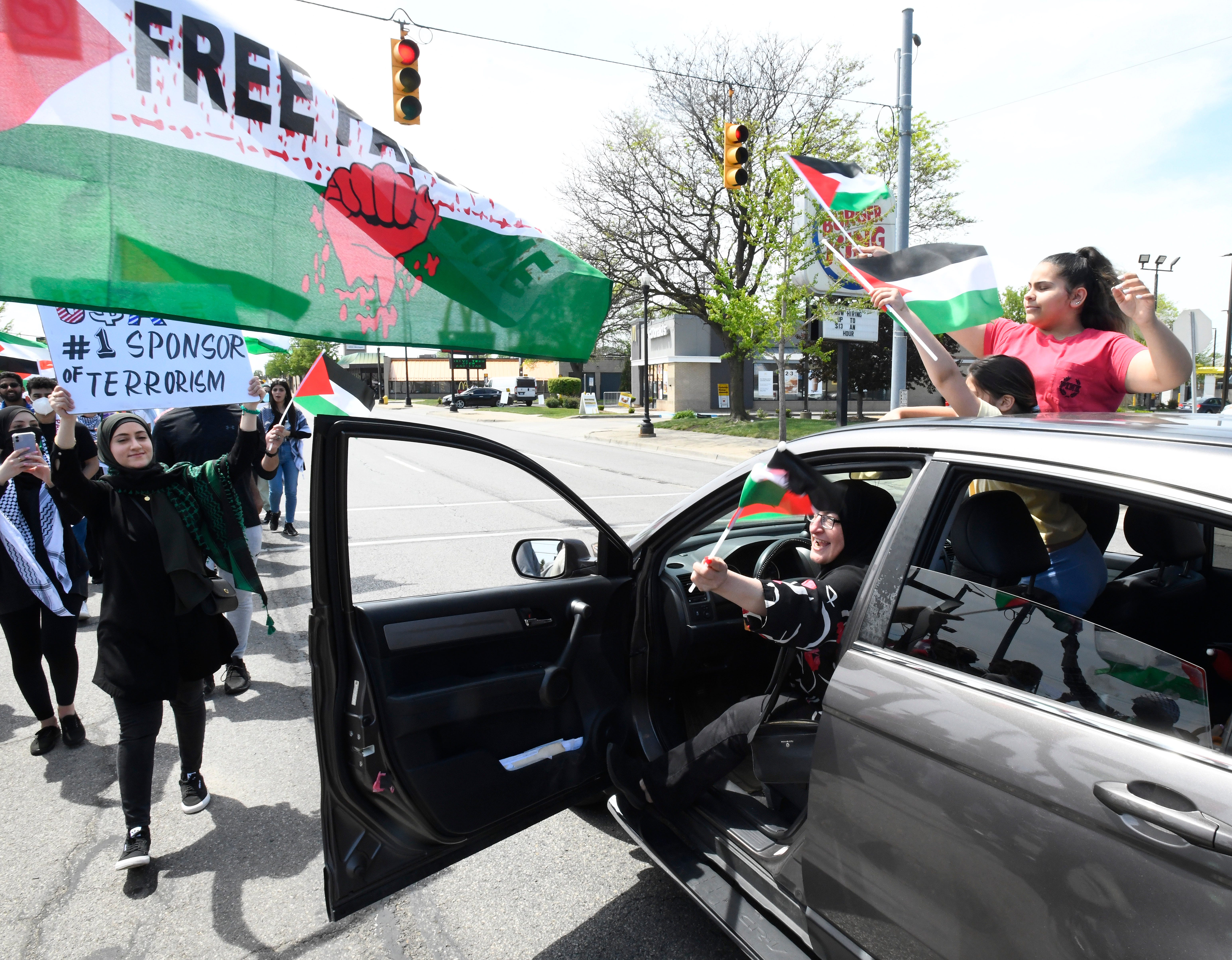 Cars pull over and show support as thousands of Palestinian supporters march down westbound Michigan Avenue during a Palestinian protest and march, at the same time President Joe Biden is visiting in another part of Dearborn, Michigan on May 18, 2021.