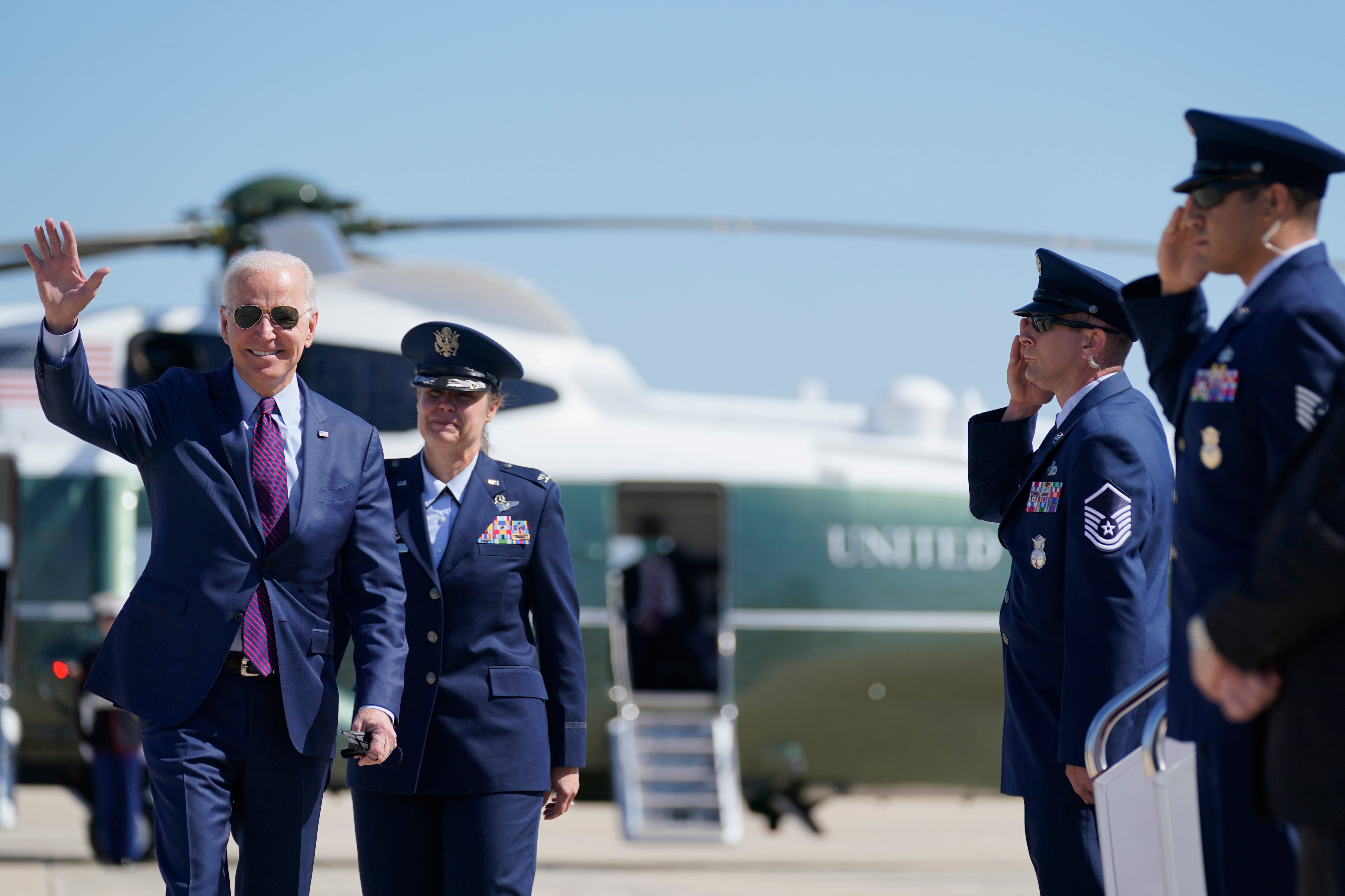 President Joe Biden waves as he walks to board Air Force One for a trip to Michigan to visit a Ford plant, Tuesday, May 18, 2021, in Andrews Air Force Base, Md.