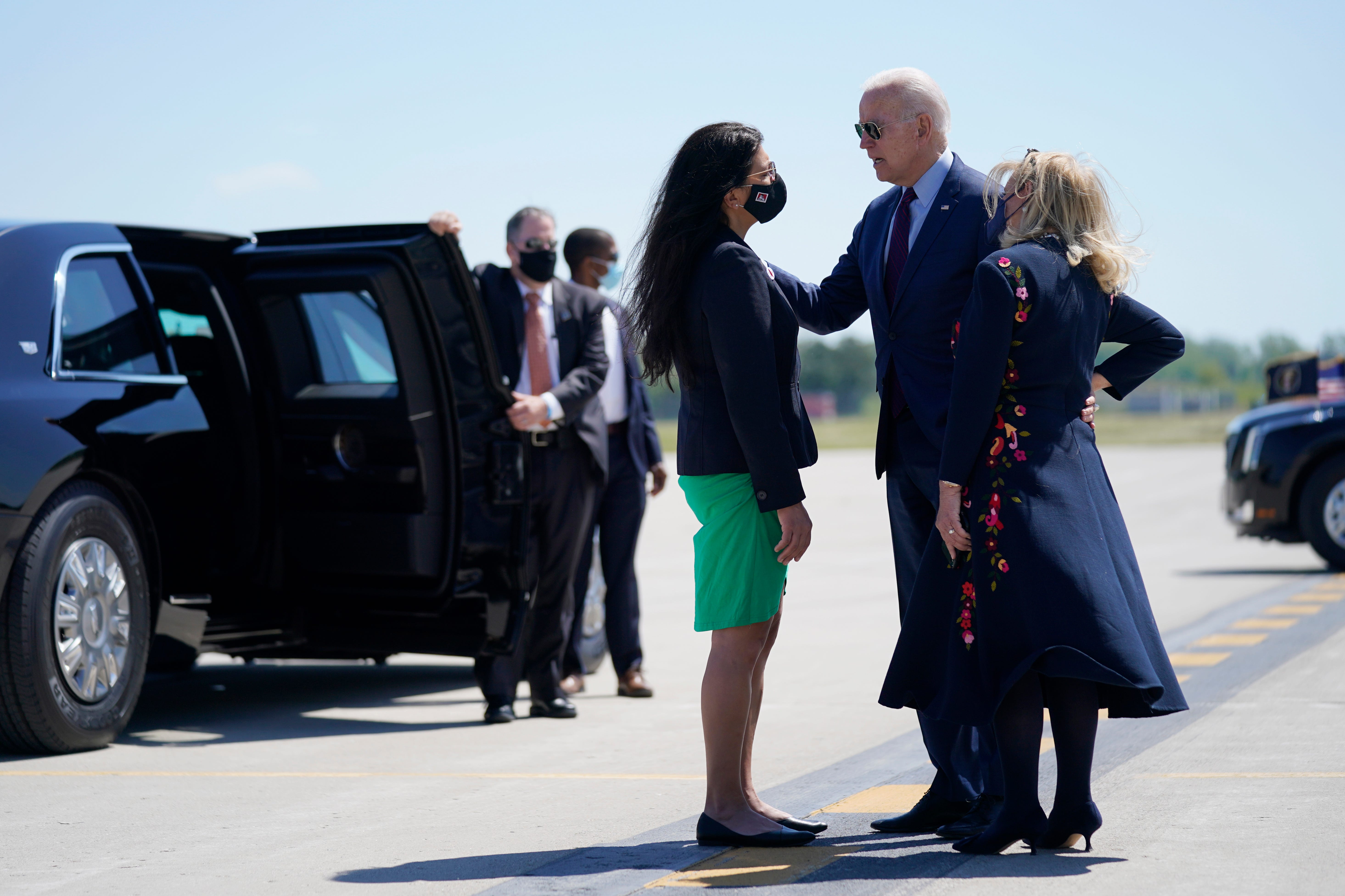 President Joe Biden speaks with Rep. Rashida Tlaib, D-Mich., and Rep. Debbie Dingell, D-Mich, right, as he arrives at Detroit Metropolitan Wayne County Airport.