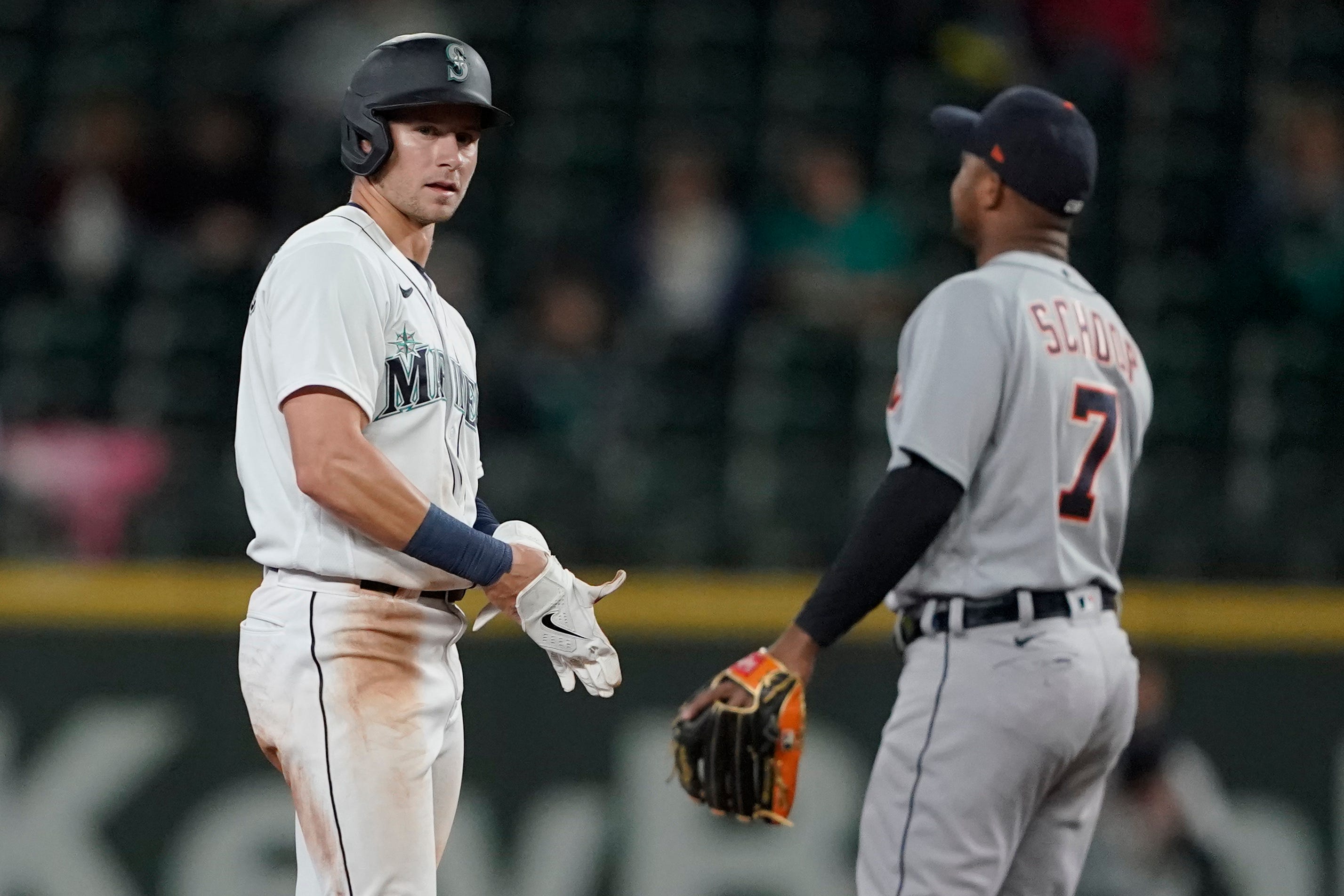 Seattle Mariners' Jarred Kelenic, left, stands on second base after a steal, as Detroit Tigers second baseman Jonathan Schoop, right, walks back to his position during the fourth inning.