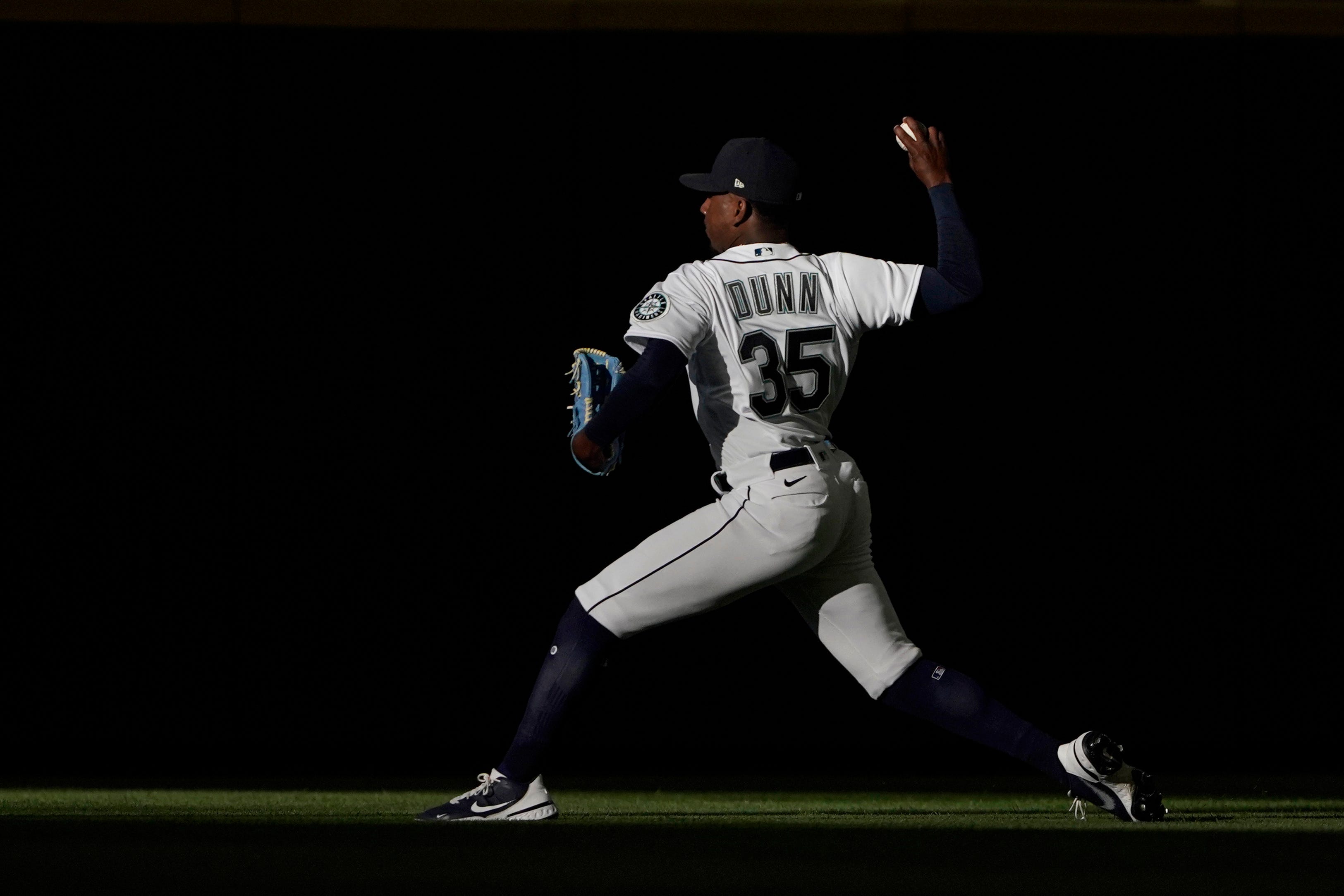 Seattle Mariners starting pitcher Justin Dunn warms up in a section of sunlight with the roof at the stadium extended, before the team's baseball game against the Detroit Tigers, Tuesday, May 18, 2021, in Seattle.