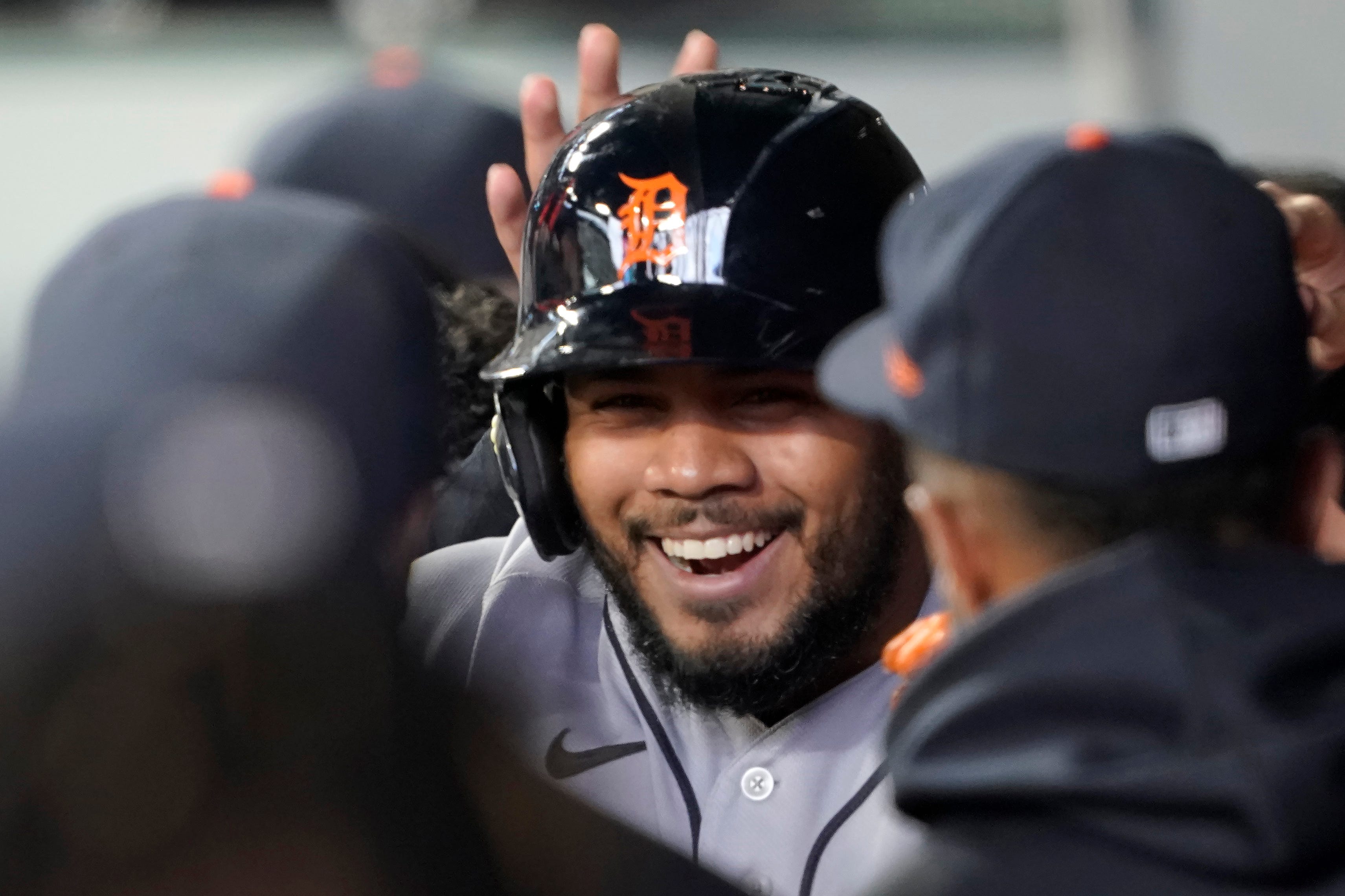 Detroit Tigers' Jeimer Candelario is greeted in the dugout after he hit a solo home run against the Seattle Mariners during the first inning.
