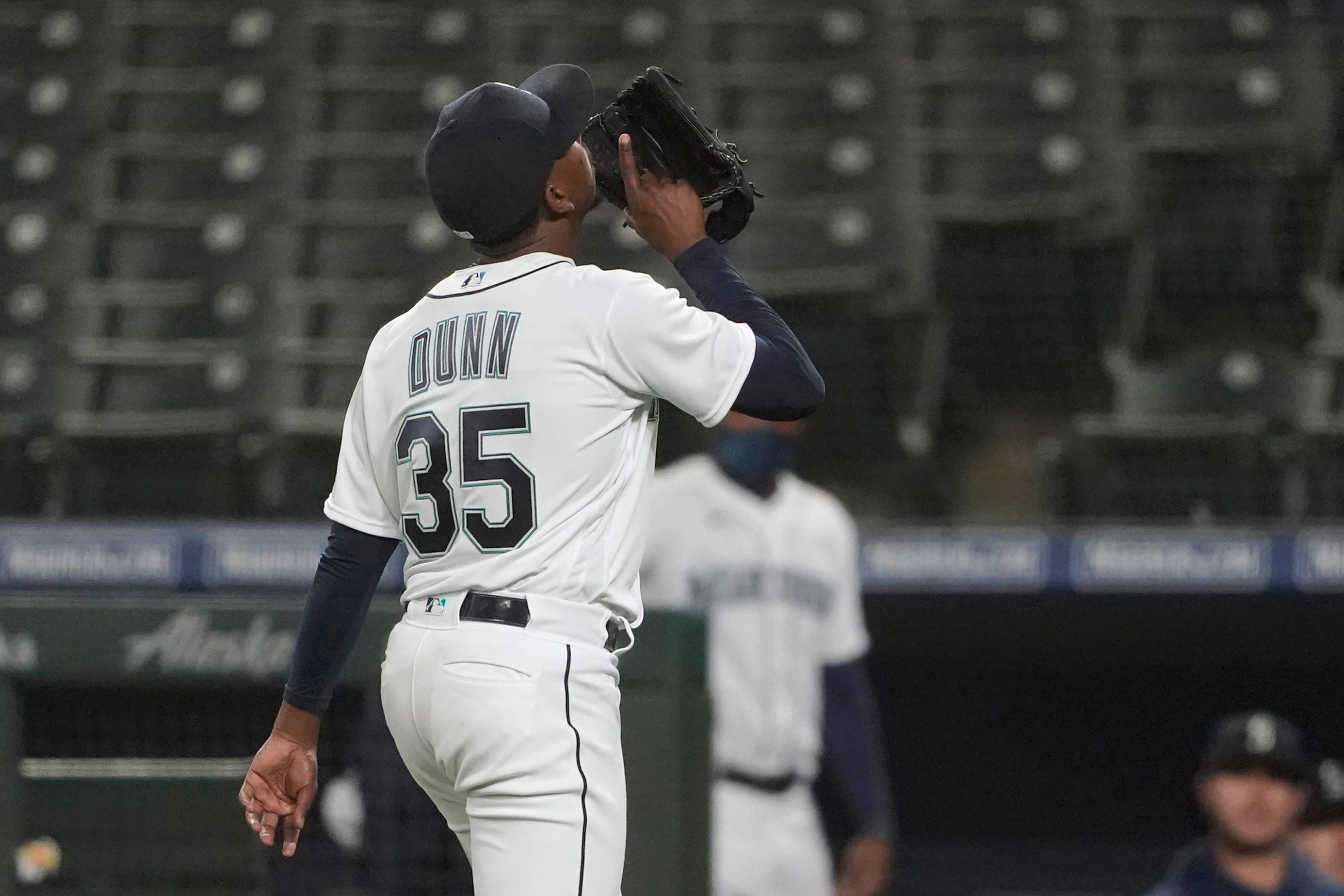 Seattle Mariners starting pitcher Justin Dunn walks off the field after being pulled from the game.