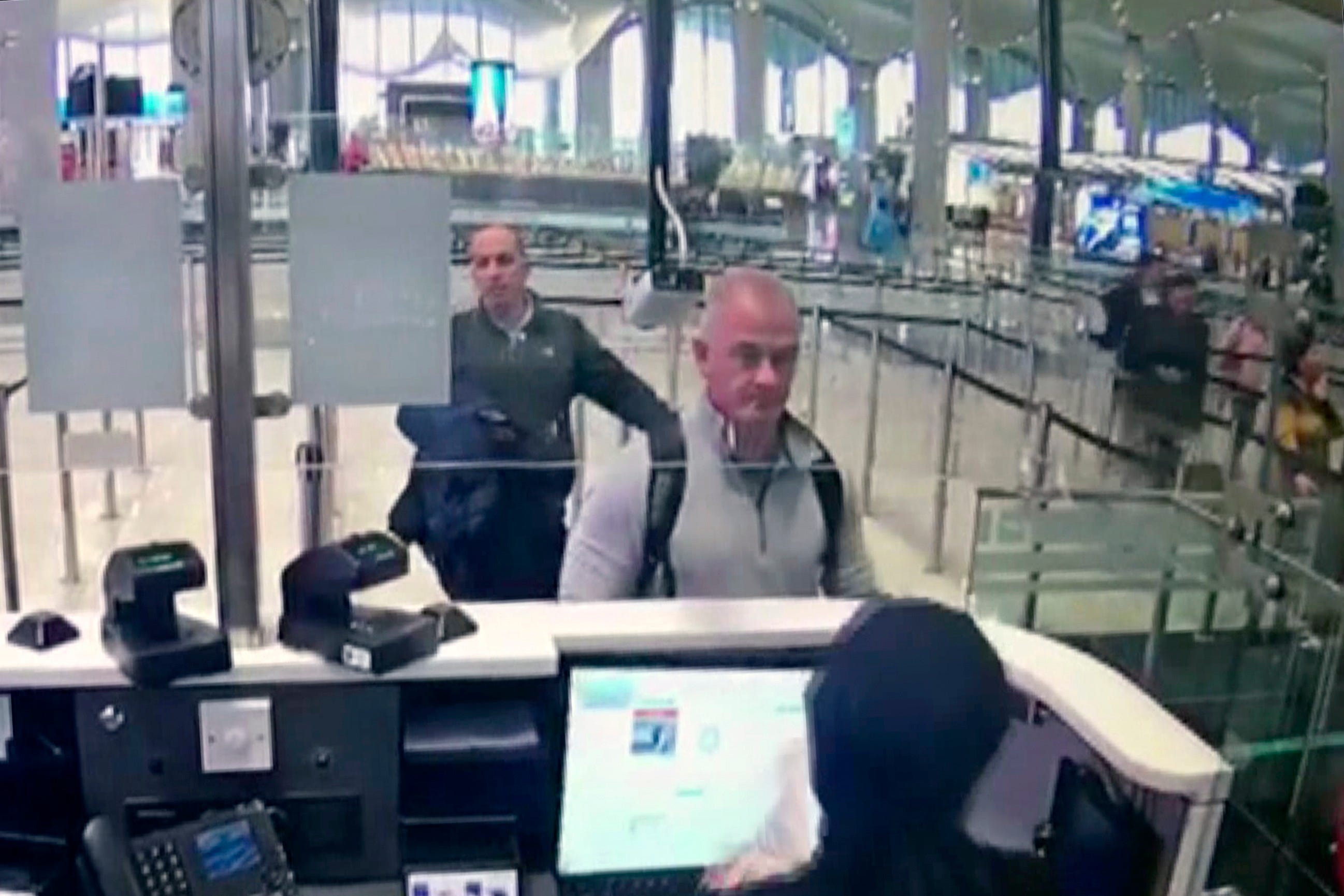 This Dec. 30, 2019 image from security camera video shows Michael L. Taylor, center, and George-Antoine Zayek at passport control at Istanbul Airport in Turkey.