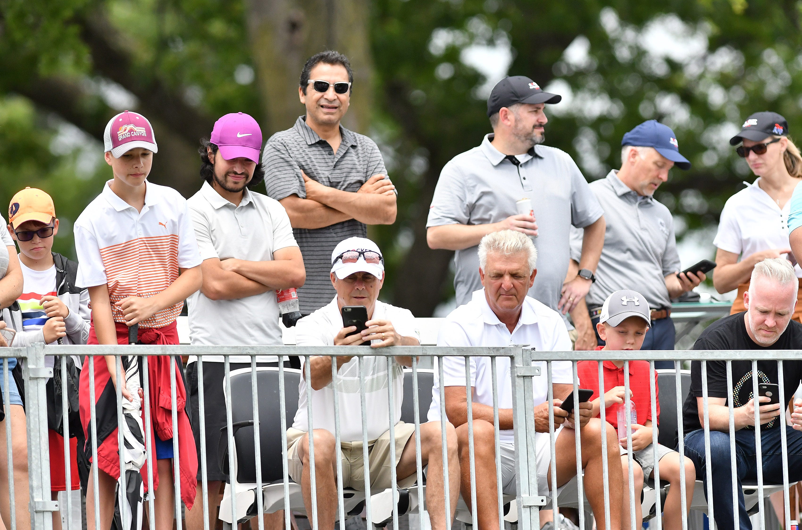 Fans watch Bryson DeChambeau about to tee off on hole No. 16.