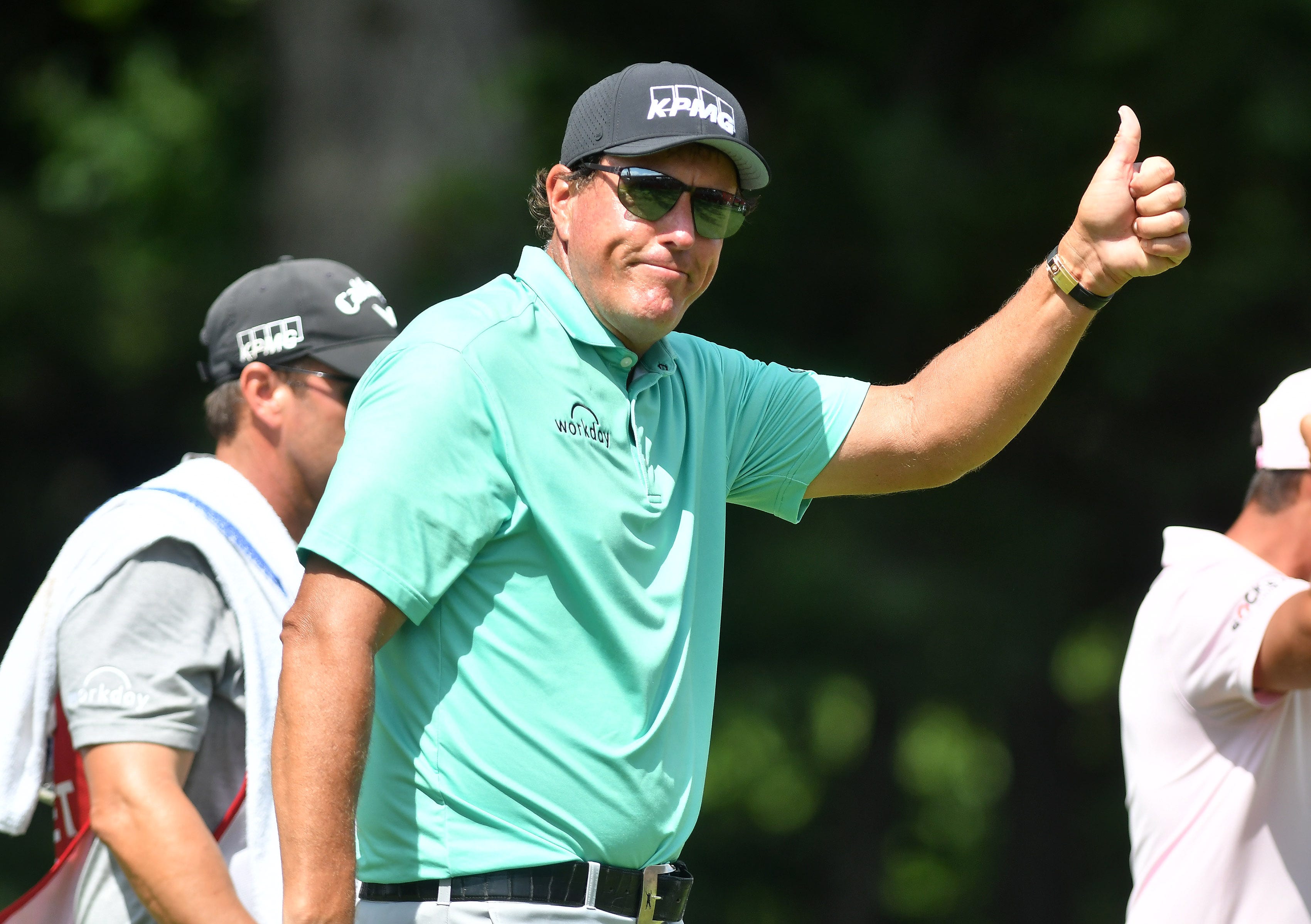 Phil Mickelson gives a thumbs up to the fans after finishing his round on the ninth green during Round 1 of the Rocket Mortgage Classic at the Detroit Golf Club on July 1, 2021.