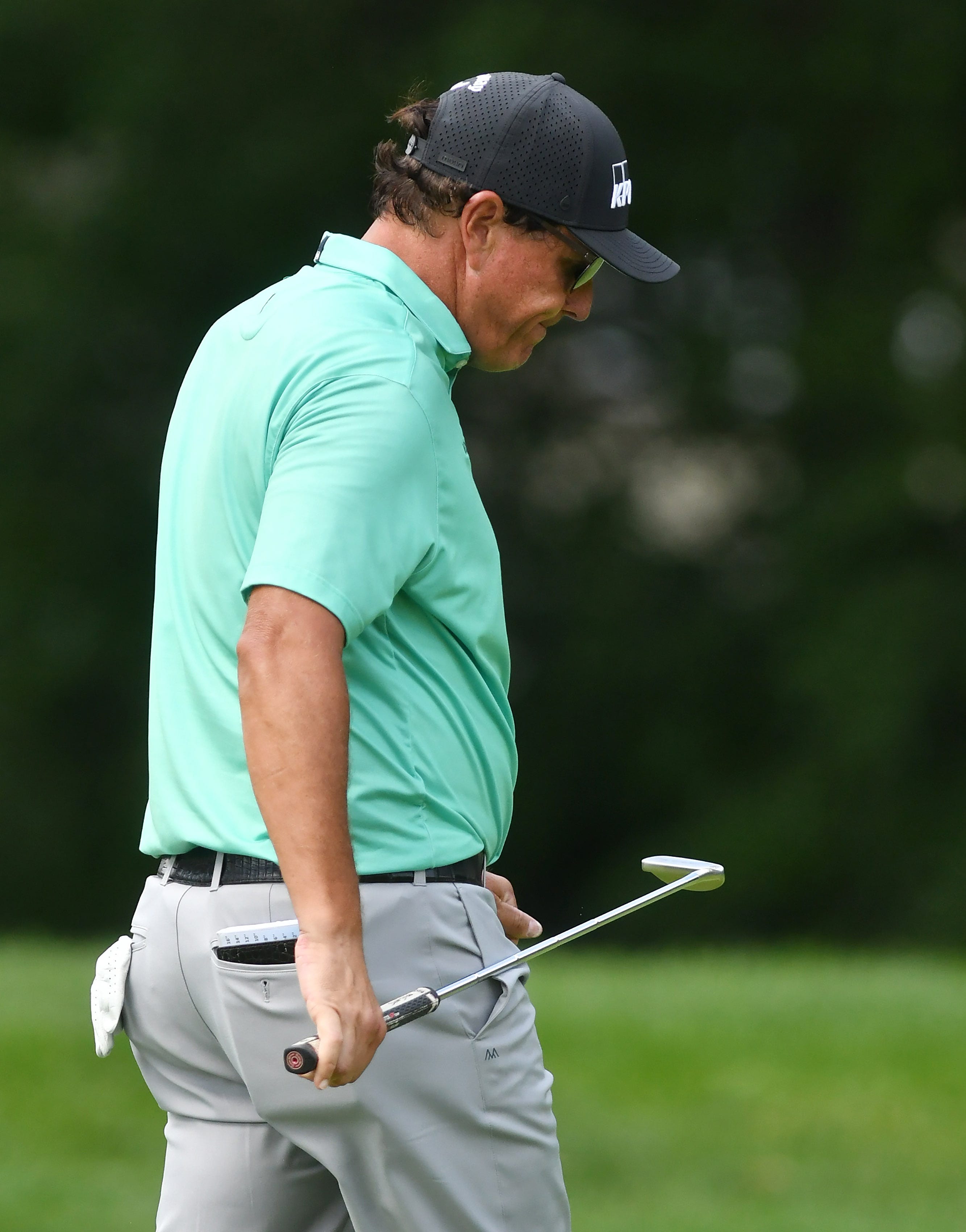 Phil Mickelson reacts after missing a putt on the ninth green.
