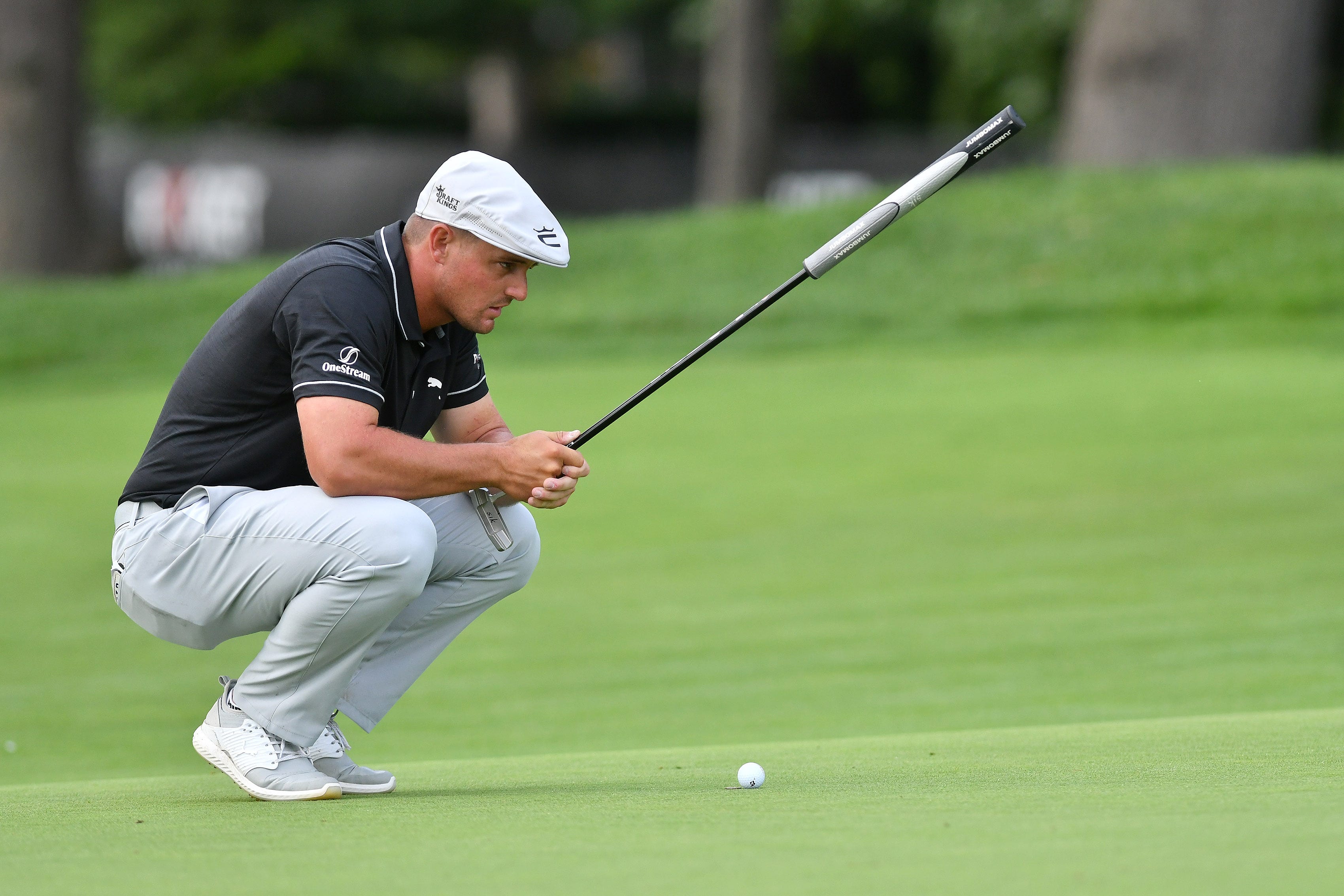 Bryson DeChambeau lines up his putt on the 9th green in Round 1.