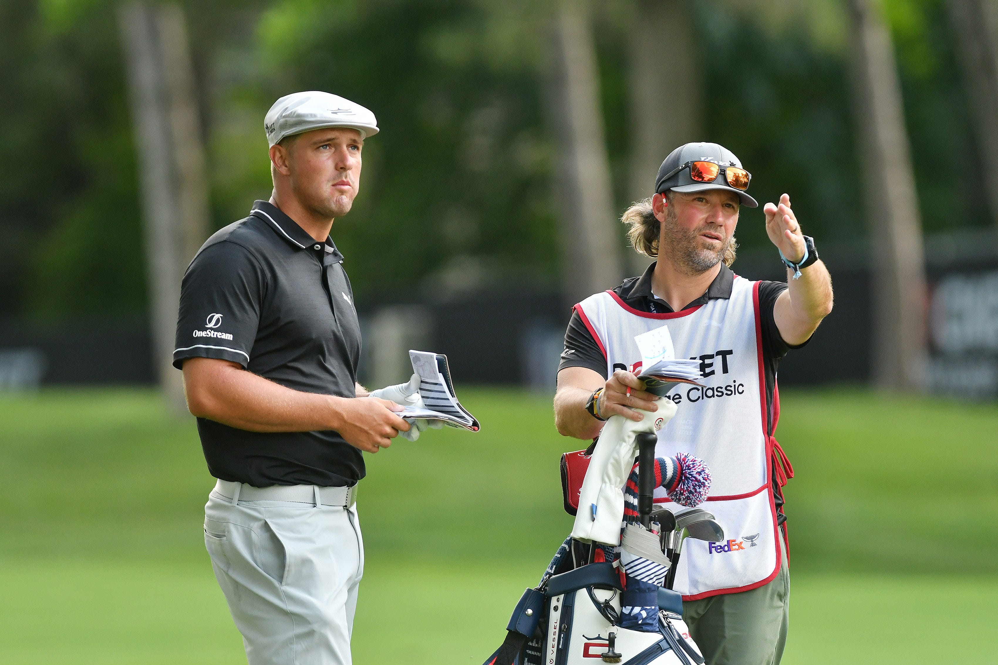 From left, Bryson DeChambeau with his new caddie Ben Schomin look over the eighth fairway in Round 1.